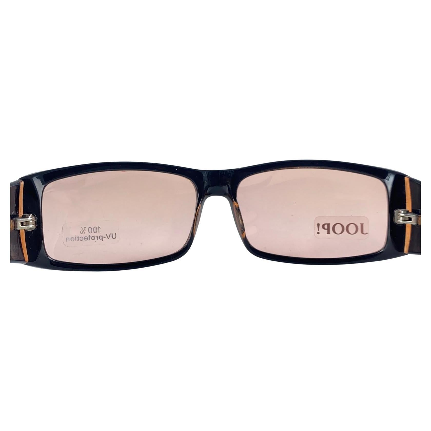 




 

New Vintage Joop! 1990'S Mod 87005 Dark Brown  Frame Sunglasses Made In Germany.

Ligh Brown Slight Mirrored Lenses.

New, Never Worn Or Displayed.

This Item May Show Minor Sign Of Wear Due To Storage.

Front : 14 Cms
Lens Height : 3.5 
