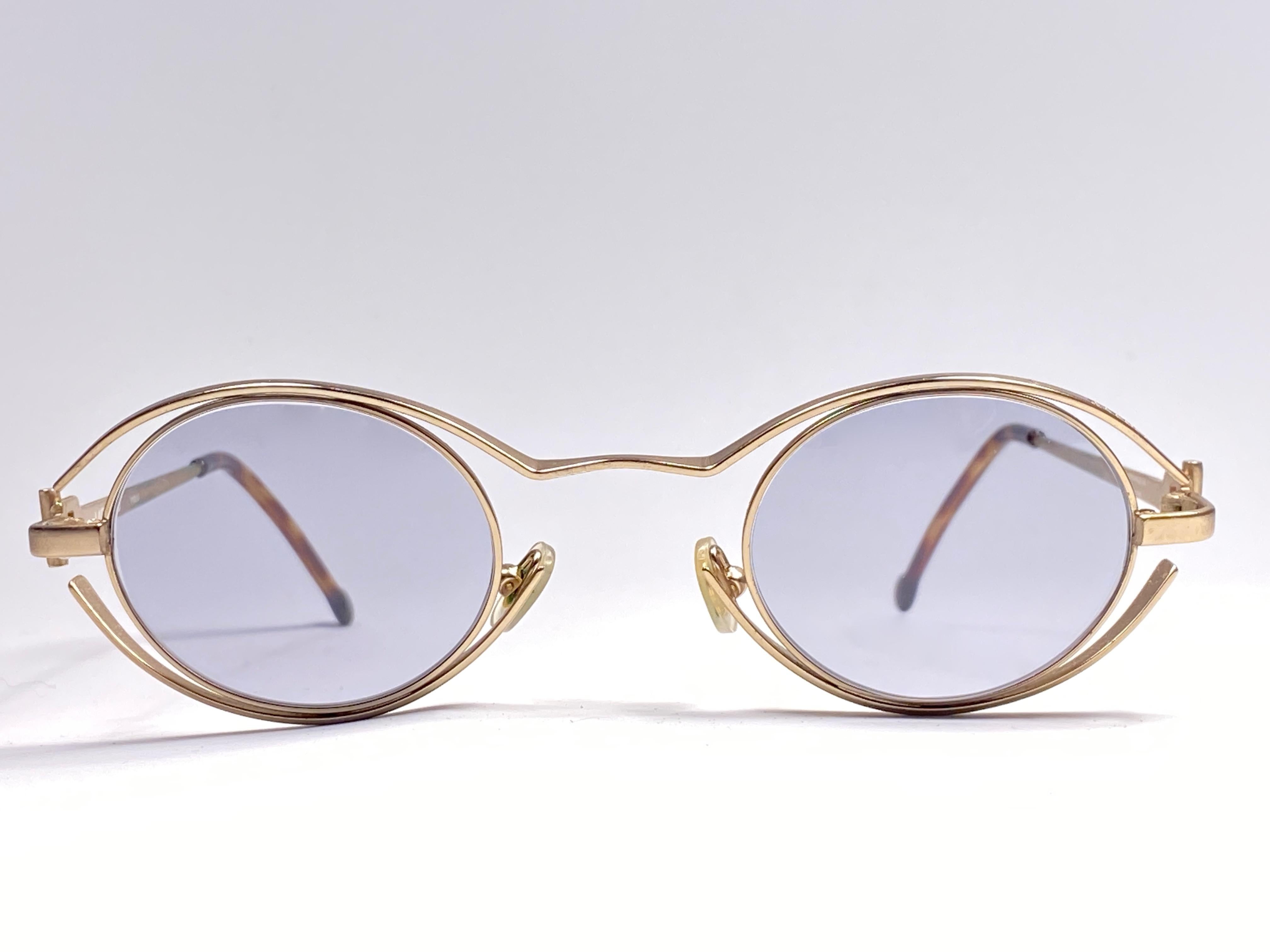 New Vintage amazing pair of vintage 1980's 4123 Karl Lagerfeld oval matte gold sunglasses framing a pair of light grey lenses.
 
 New, never worn or displayed. Designed and produced in France.

This item may show minor sign of wear due to storage.
