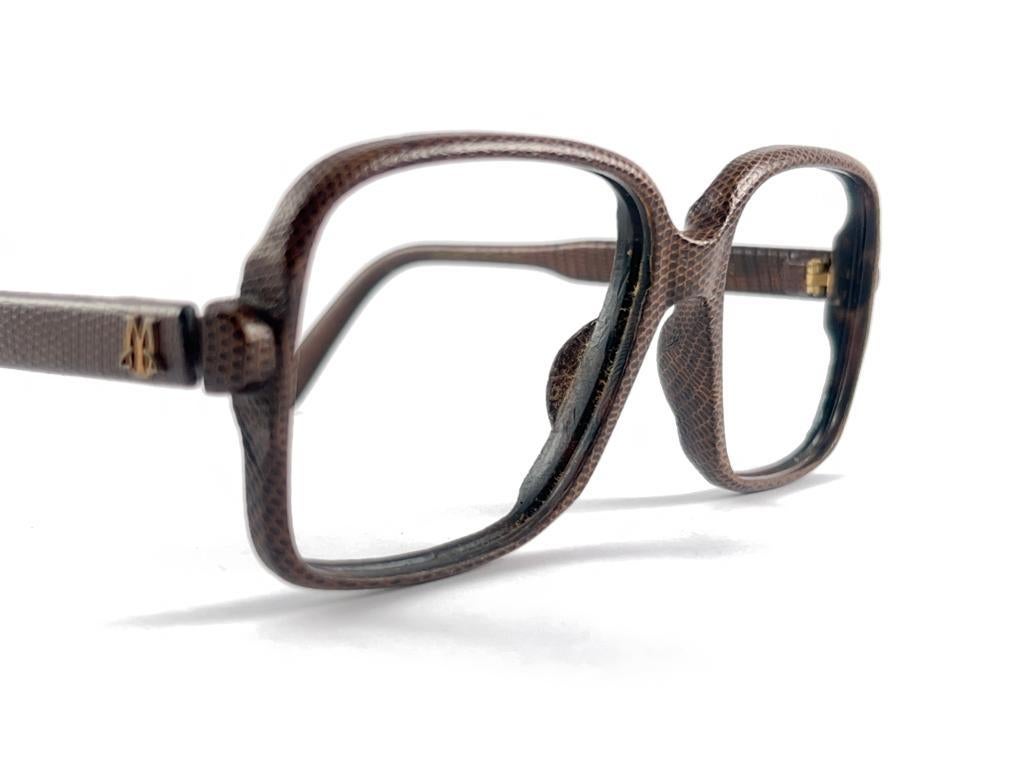 New, rare Maxim's de Paris completely lined with real lizard leather frame with legendary Maxim's logo on the temples. Suitable for RX, prescription glasses use. 

Please notice that this item is nearly 40 years old and could show some storage wear.