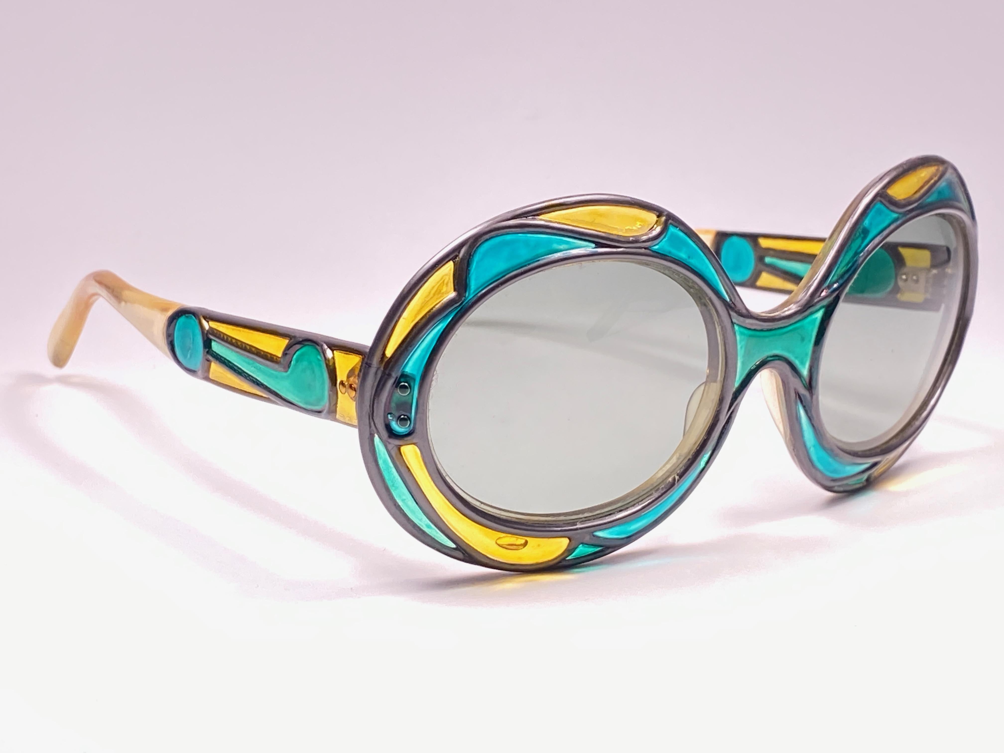 New Vintage Collector Item 1950'S Michelle Brevet Stained Glass Like Technique Over An Acetate Frame Holding A Spotless Pair Of Light Grey Lenses. 
Handmade In France In The 50'S.

This Pair May Show Minor Sign Of Wear Due To Storage.



Front :    