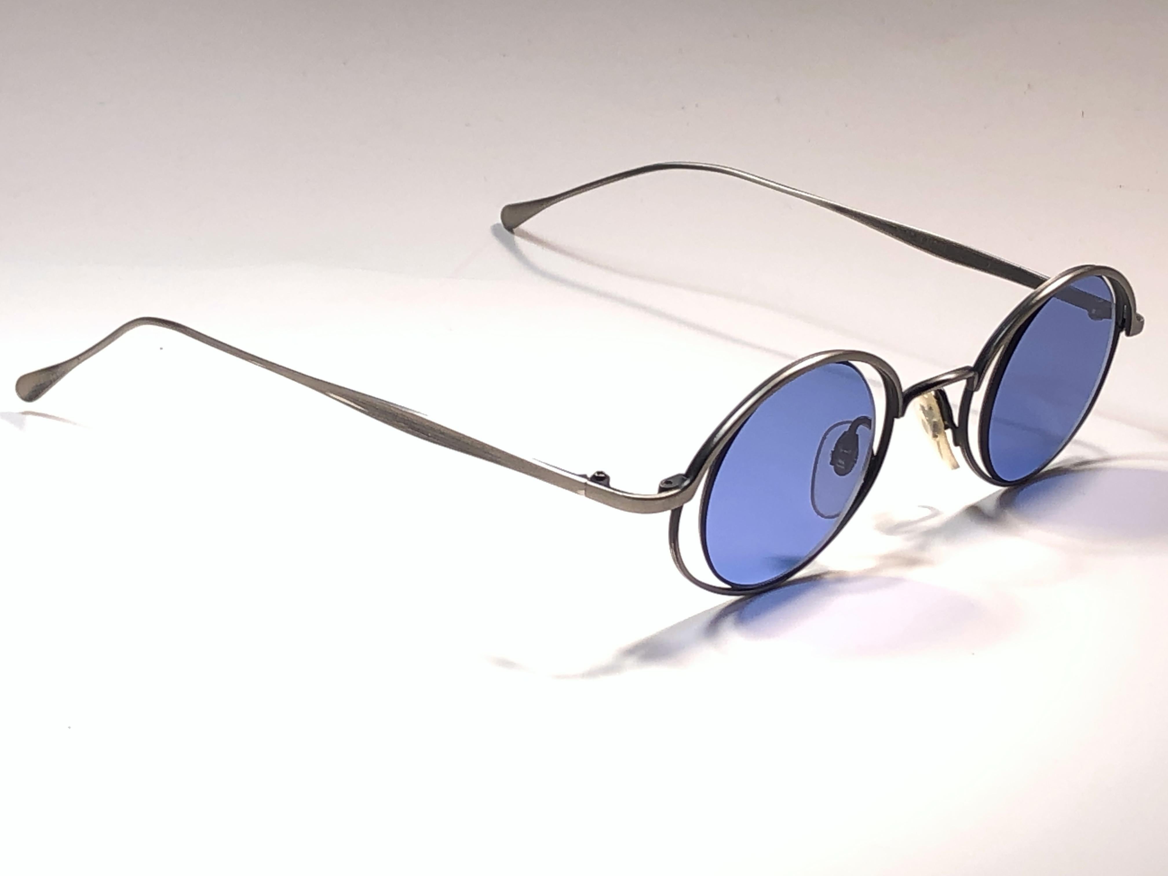 Rare Miyake Design Studio signed this pair of rare matte silver with inner framed lenses sunglasses.   

Blue lenses with ultra light scratches due to storage.  

Superior quality and design. Original case.

This item show minor sign of wear due to