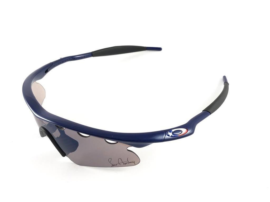 
New Vintage Oakley Lance Armstrong  Frame Sunglasses. Wrap navy blue frame with printed signed lenses.
New never worn or displayed. This item might show minor sign of wear due to storage.
Comes with its original box and papers as pictured.
Made in