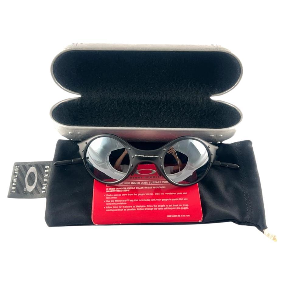 
New Vintage Oakley Moon Sunglasses. 
Black Matte frame with mirror lenses.
New never worn or displayed. This item might show minor sign of wear due to storage.
Comes with its original box and papers as pictured.
Made in Usa