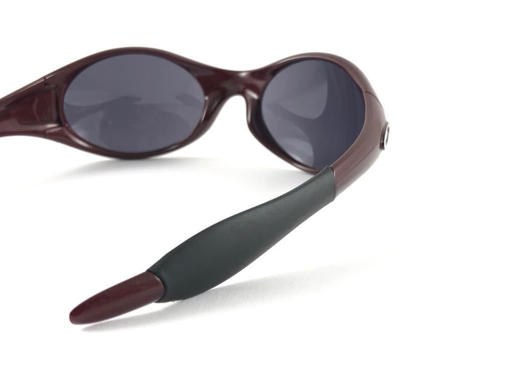 
New Vintage Oakley Trenchcoat Sunglasses. Burgundy  sports frame with mirrored lenses.
New never worn or displayed. This item might show minor sign of wear due to storage.
Comes with its original box and papers as pictured.
Made in Usa