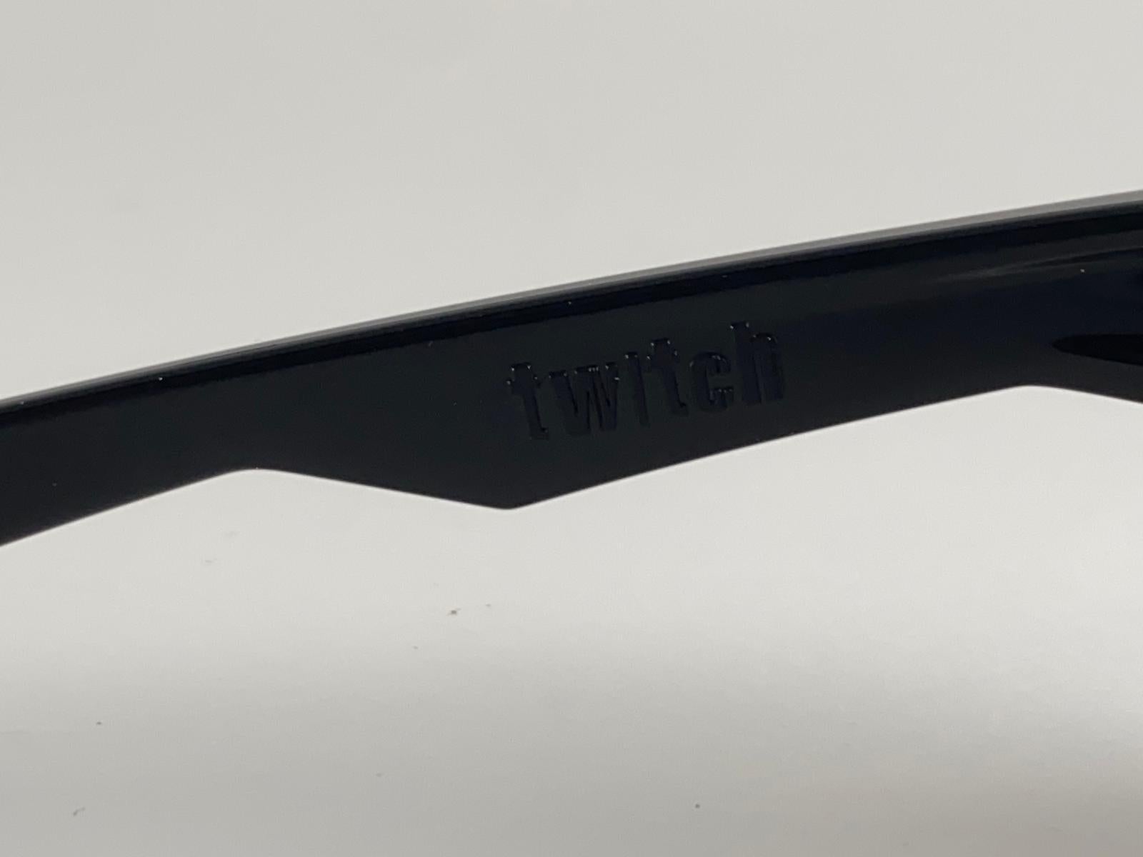 
New Vintage Oakley Twitch Black Frame Sunglasses. Polished Black sports frame with mirrored lenses.
New never worn or displayed. This item might show minor sign of wear due to storage.

Made in Usa