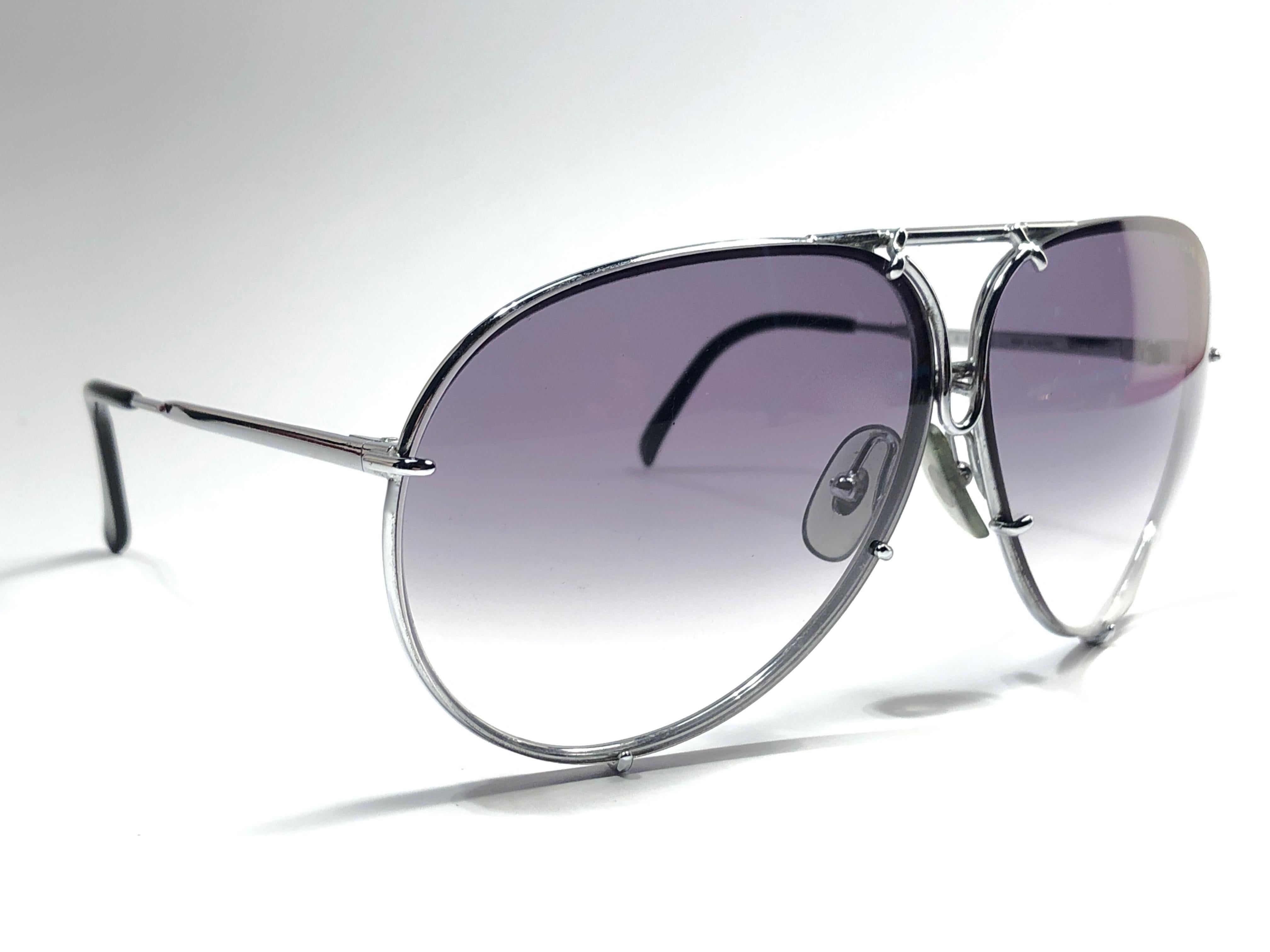 New 1980's Porsche Design 5623 silver oversized frame with grey gradient lenses.  

Amazing craftsmanship and quality.  
Comes with the original black Porsche hard case thats has some wear on it due to nearly 40 years of storage. This item show