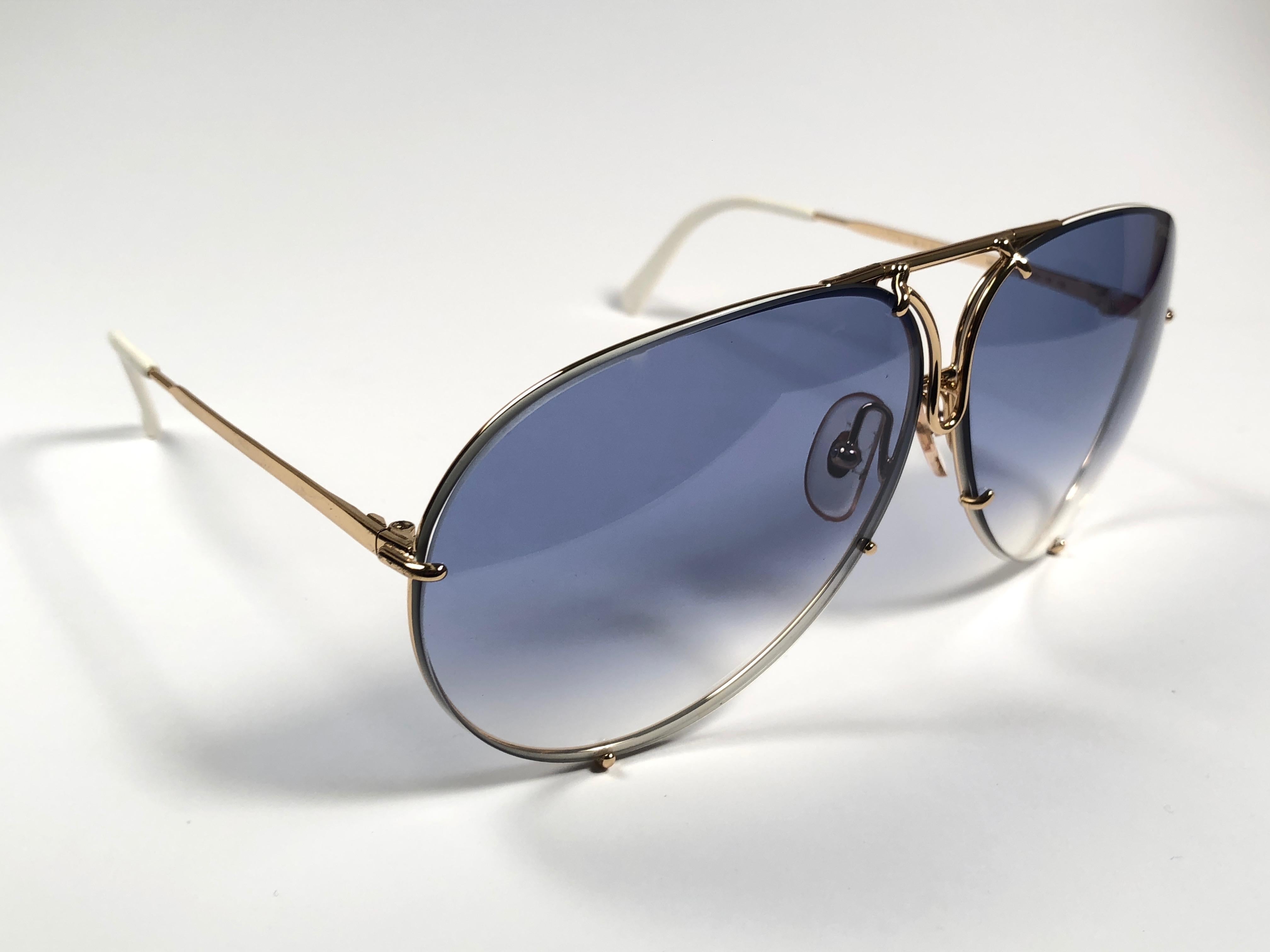 
New 1980's Porsche Design 5621 white and gold frame with blue gradient lenses. Amazing craftsmanship and quality. 
Comes with the original black Porsche hard case thats has some wear on it due to nearly 40 years of storage. There is no extra set of