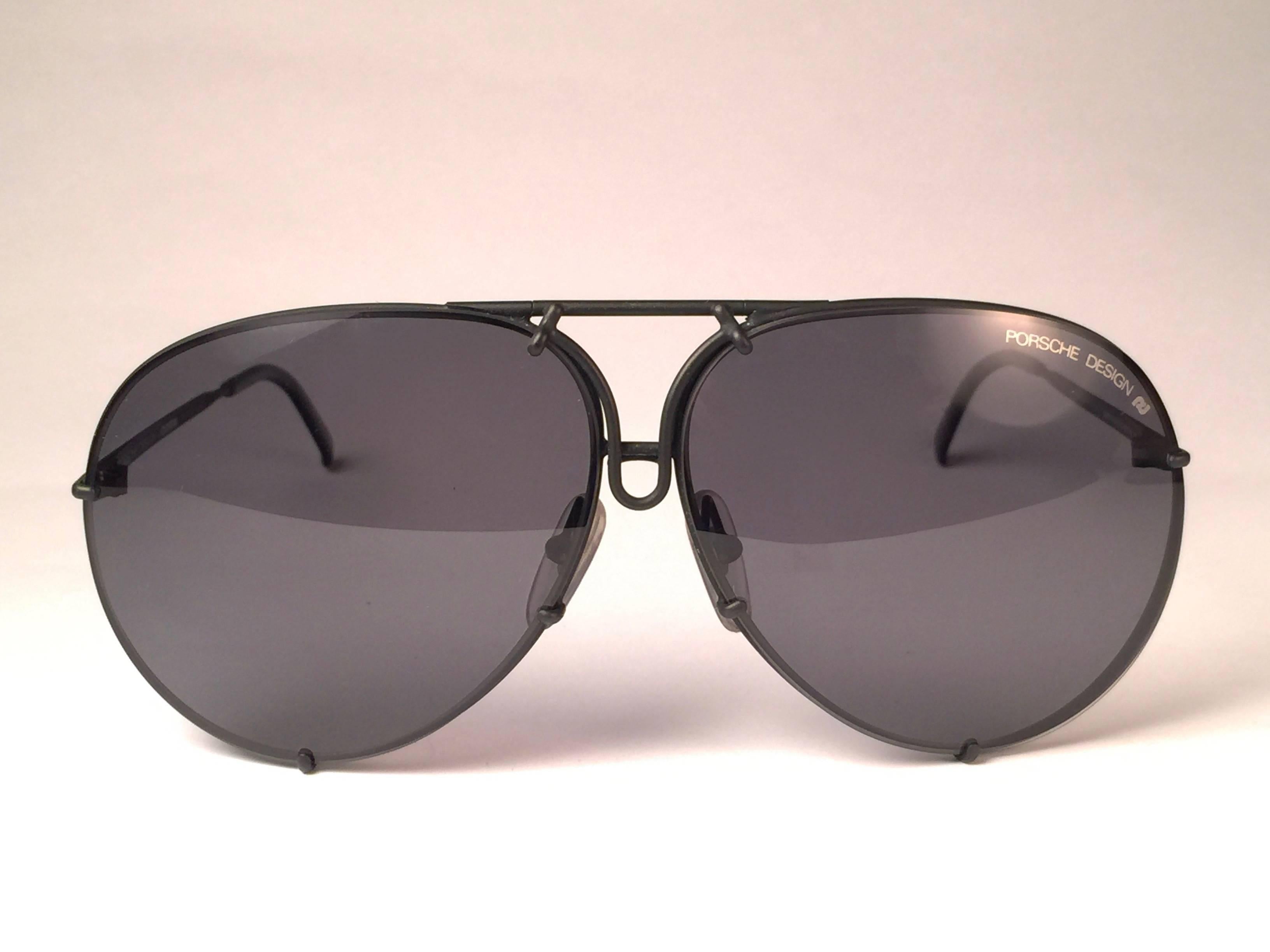 New 1980's Porsche Design 5623 black Matte frame with grey lenses. 
Amazing craftsmanship and quality.  
Comes with the original black Porsche hard case thats has some wear on it due to nearly 40 years of storage.
There is no extra set of lenses for