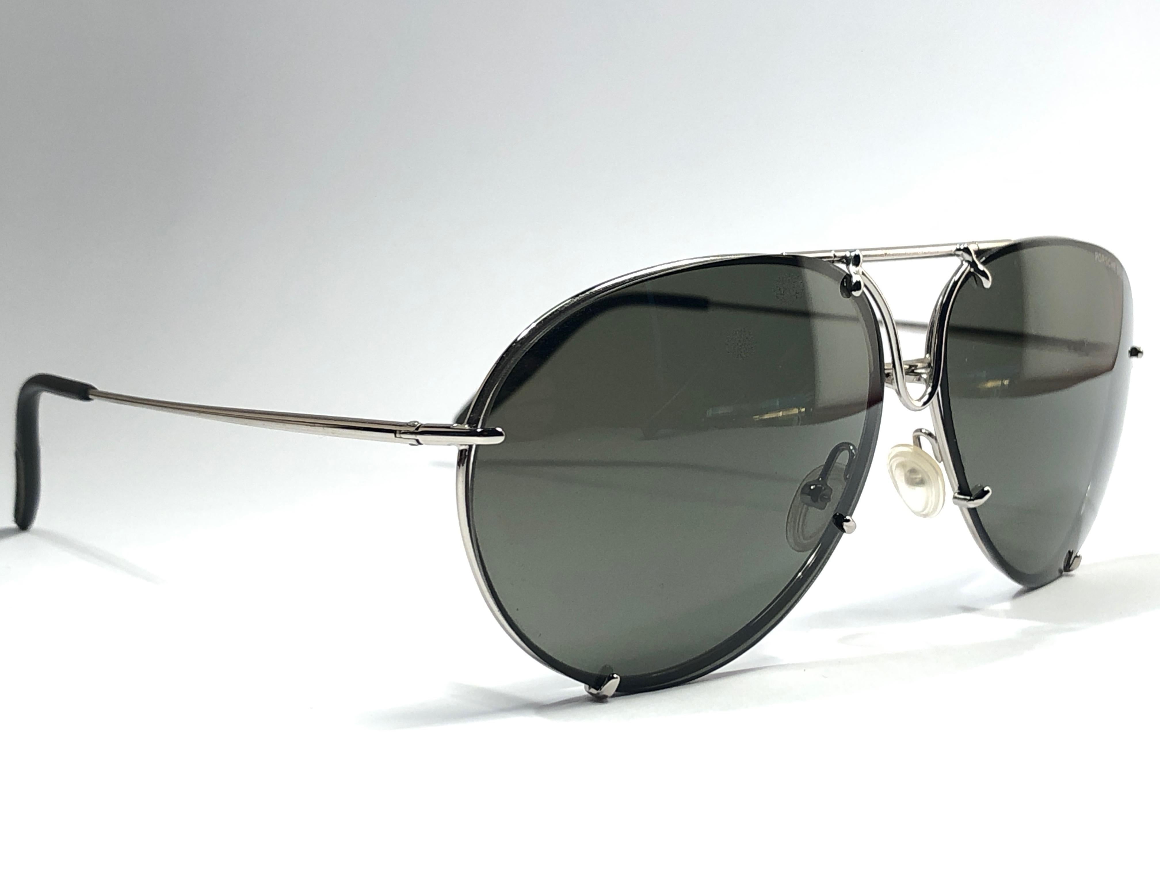 New 1980's Porsche Design P1010 silver medium aviator frame with smoke grey lenses.  

Amazing craftsmanship and quality.  
Comes with the original black Porsche hard case thats has some wear on it due to nearly 40 years of storage. This item show
