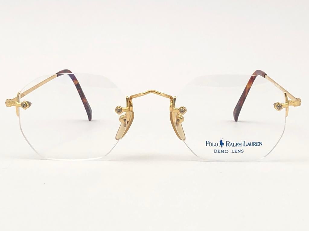 New Vintage Classic Ralph Lauren gold rimless frame ready for RX lenses.

Made in Italy.

Produced and design in 1990's.

New, never worn or displayed.
