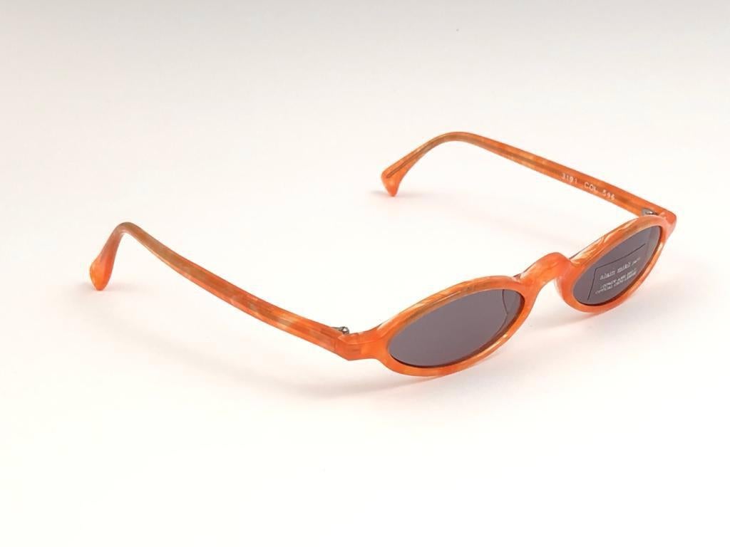 New Vintage Rare Alain Mikli tangerine frame. 

This item is in unworn condition. Please consider that this item is nearly 40 years old so it could show minor sign of wear due to storage.  

Made in France.

Front 13
Lens Height 2.2
Lens Width