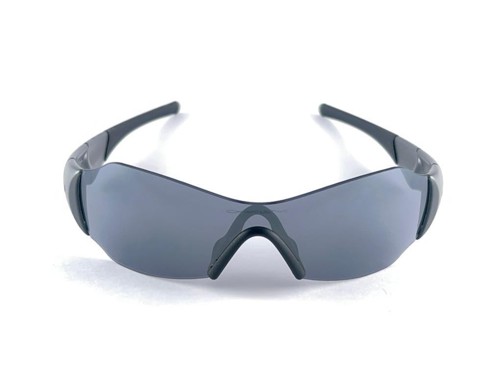 New Vintage are Oakley Sunglasses. Wrap black & grey sports frame with grey mirror lenses.
New never worn or displayed. This item might show minor sign of wear due to storage.

Made in Germany.

