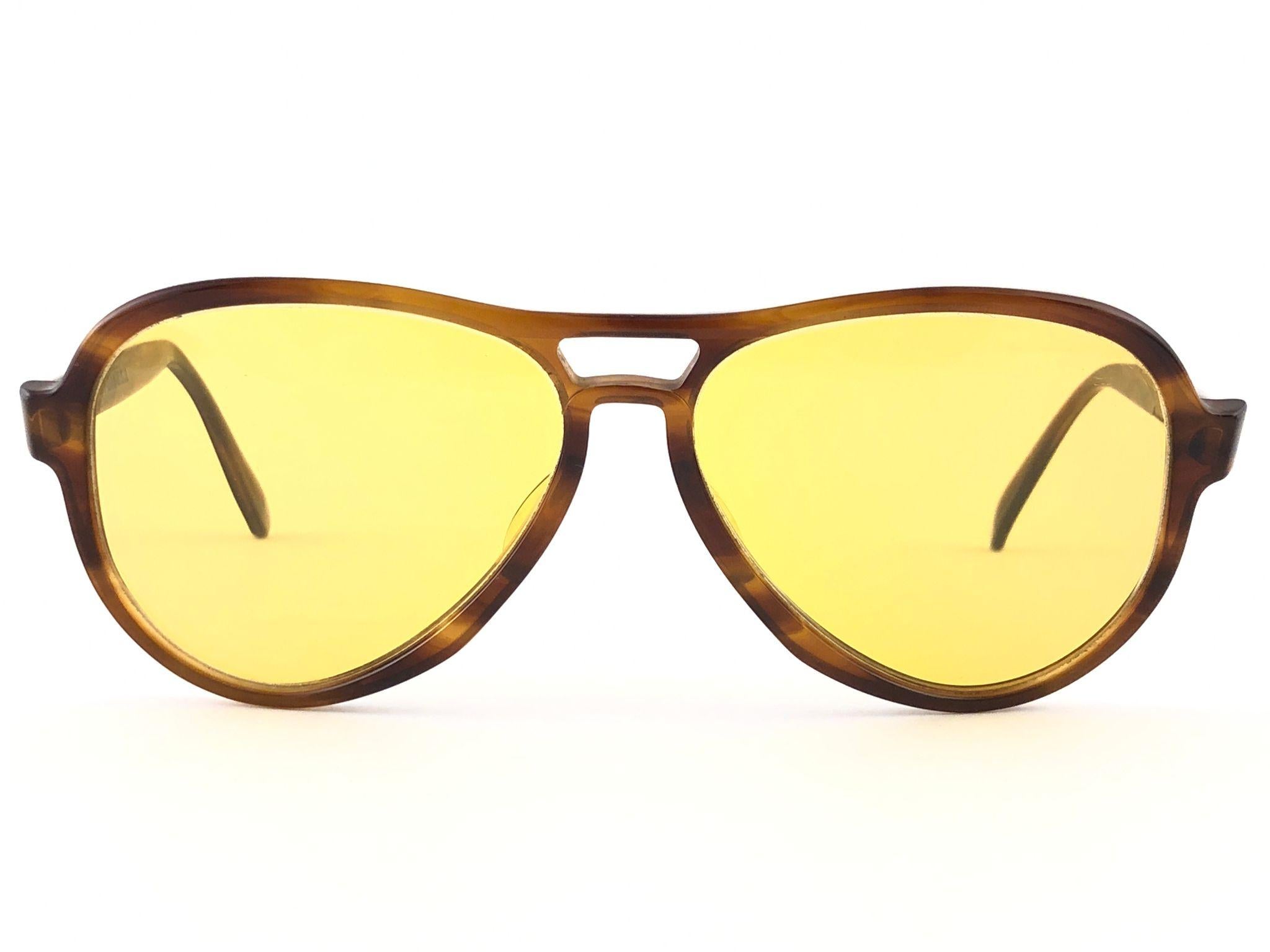 New and rare vintage Vagabond tortoise frame holding a spotless pair of Ambermatic lenses. 
New, never worn or displayed. This pair may have minor sign of wear due to nearly 40 years of storage. Designed and Produced in USA.