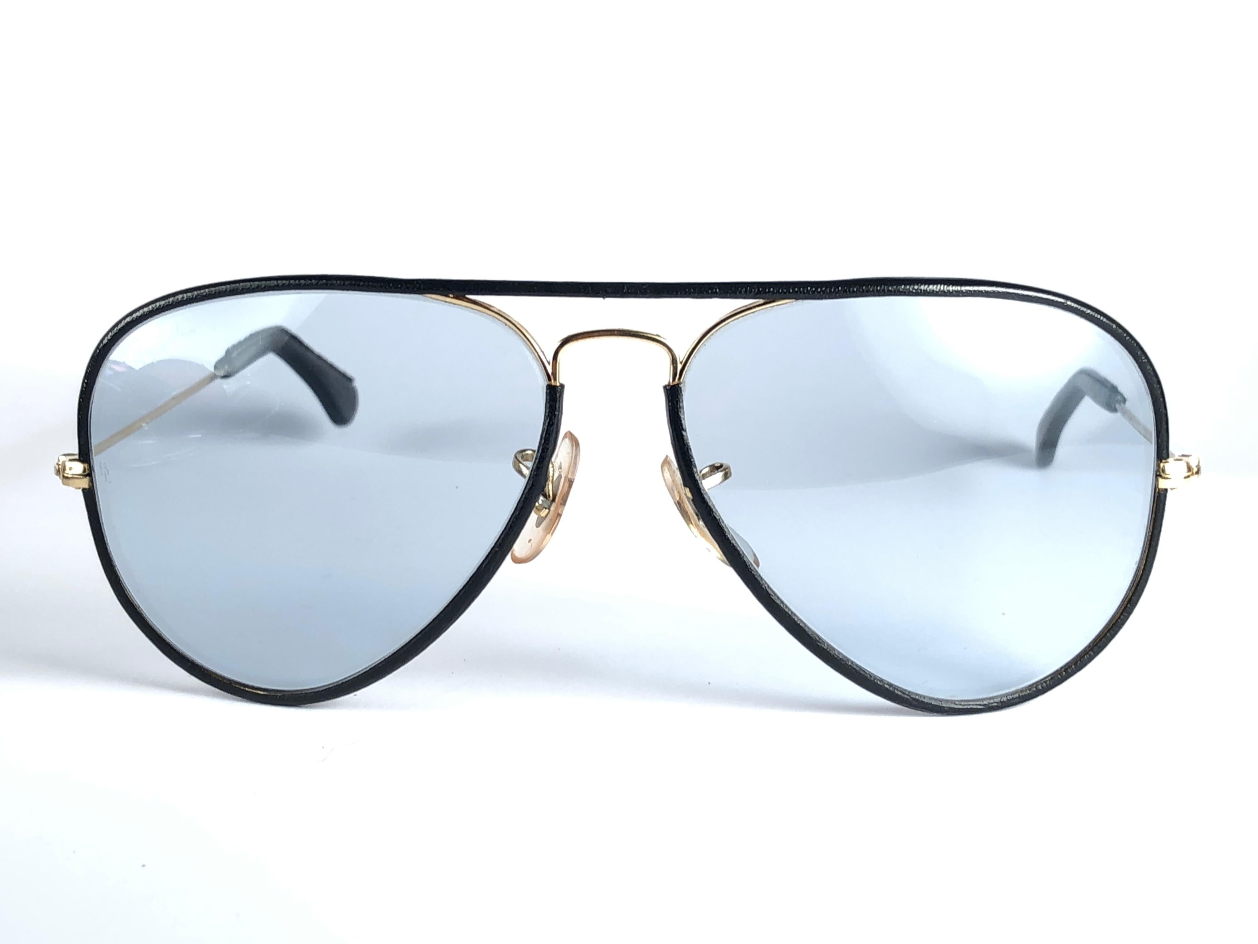 New Vintage Ray Ban Leathers Aviator 58mm in black leather with gold metal combination frame sporting blue changeable lenses.

Comes with its original Ray Ban B&L case. This pair may show minor sign of wear due to storage. 
Rare and hard to find.