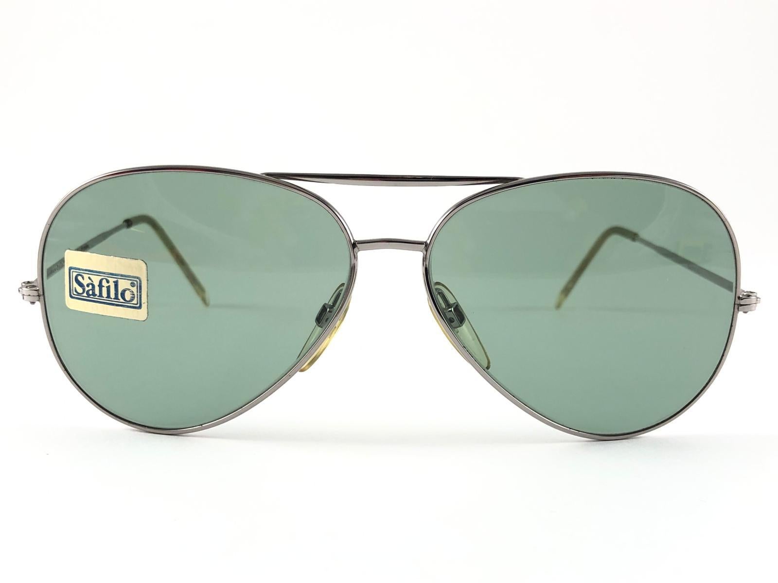 New Vintage Safilo, a balanced combination of Italian craftsmanship, design, functionality and striking aesthetics, this model showcases a really strong and unique Silver Aviator frame holding spotless Green lenses.

New, never worn or
