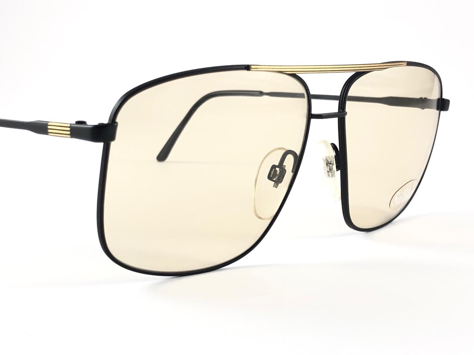 New Vintage Safilo, a balanced combination of Italian craftsmanship, design, functionality and striking aesthetics, this model showcases a Black Mate with Gold Accents frame holding a spotless light lenses.

New, never worn or displayed.
Made in