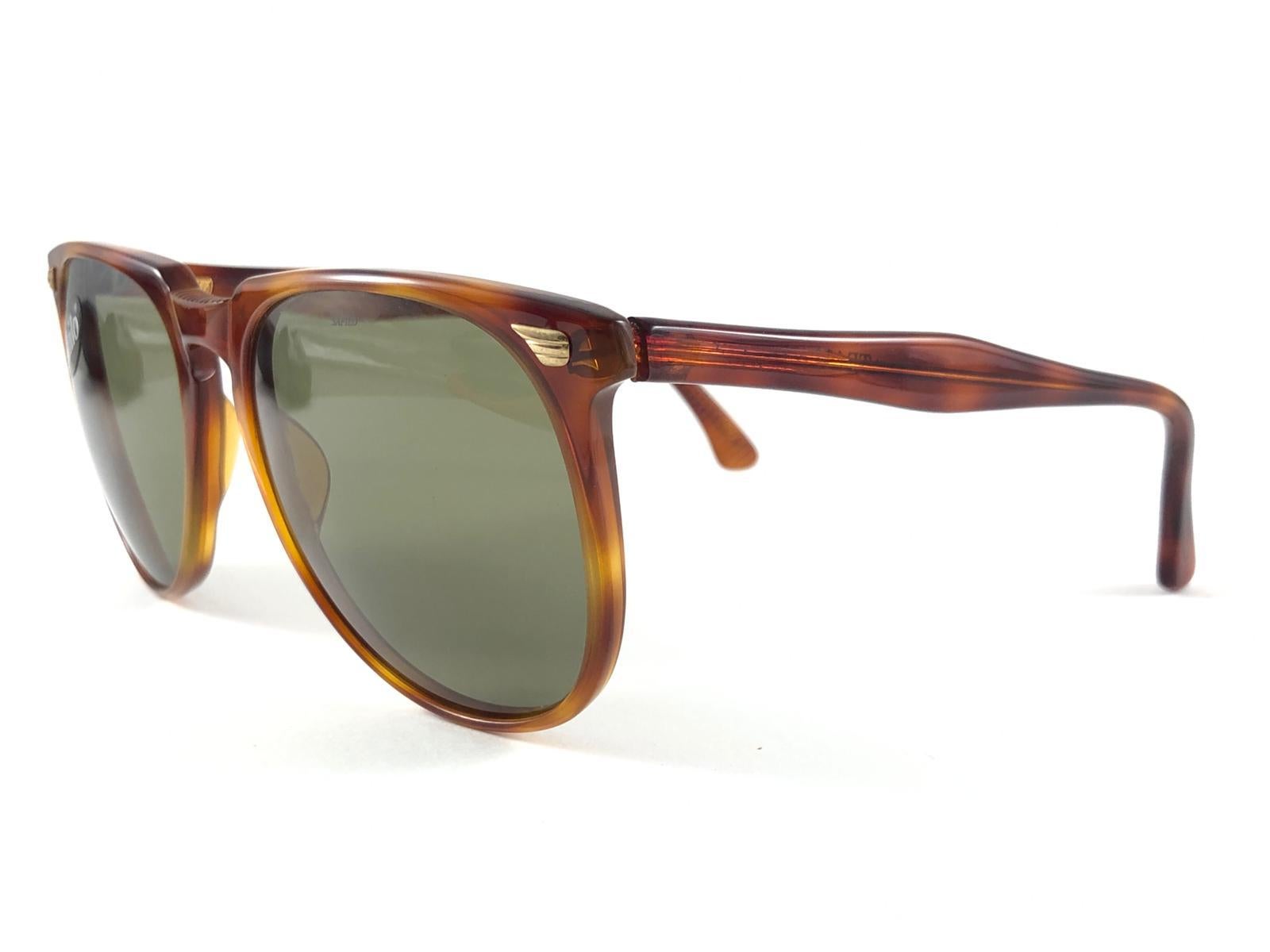 New Vintage Safilo, a balanced combination of Italian craftsmanship, design, functionality and striking aesthetics, this model showcases a Tortoise frame holding a medium Green lenses

New, never worn or displayed.
Made in