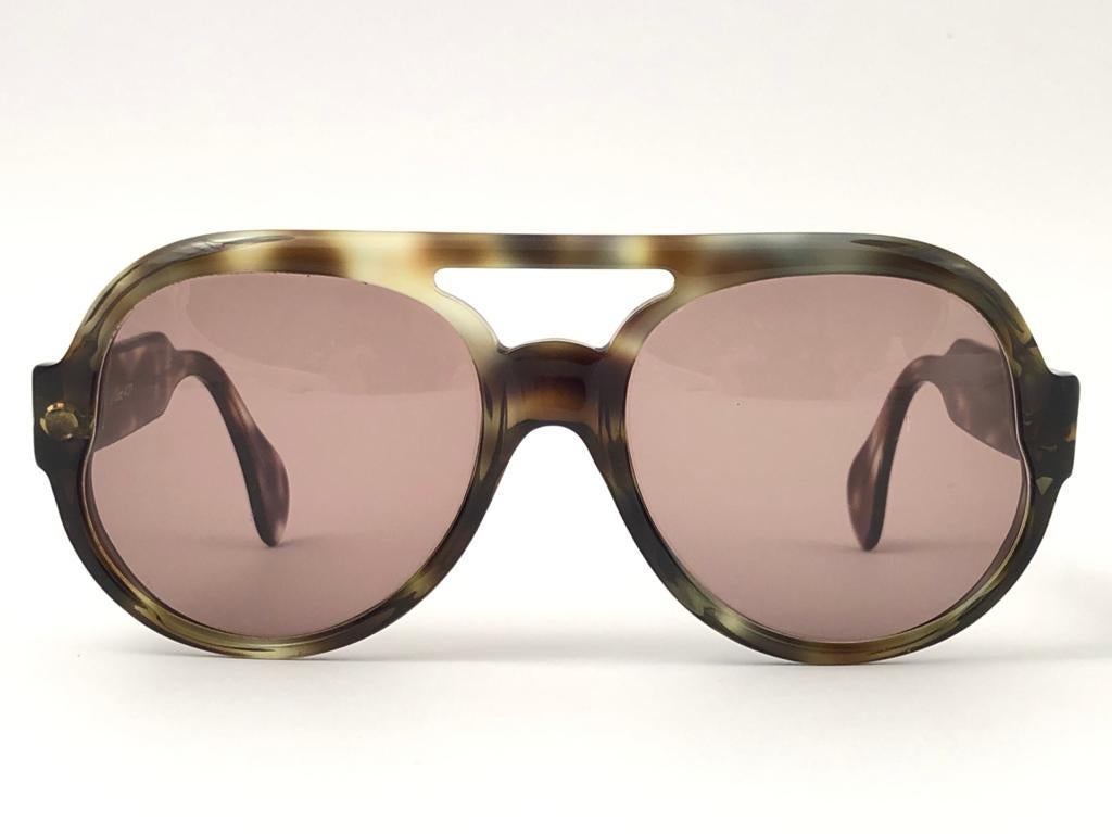 New vintage Serge Kirchhofer Oversized Sunglasses. 
Spotless lenses.
This item may show sign of wear due to many years of storage.
Made in Austria

Front  15.3 cms
Lense Hight 5.9 cms
Lense Width 5.8 cms
Temple 12.5 cms