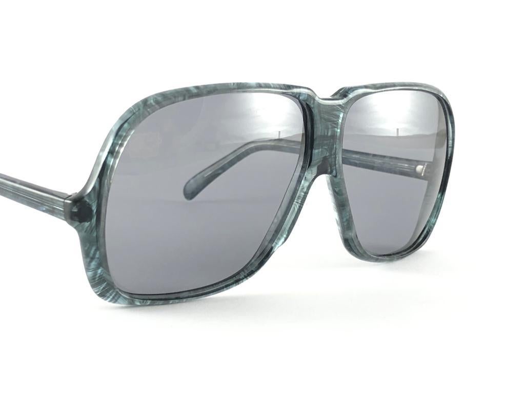 New Vintage Silhouette 785 Oversized Translucent Marbled Sunglasses frame holding a spotless pair of medium grey lenses.   

This item may show some minor sign of wear due to storage and past of time.

Made in Austria in 1970's.

Frame Width        