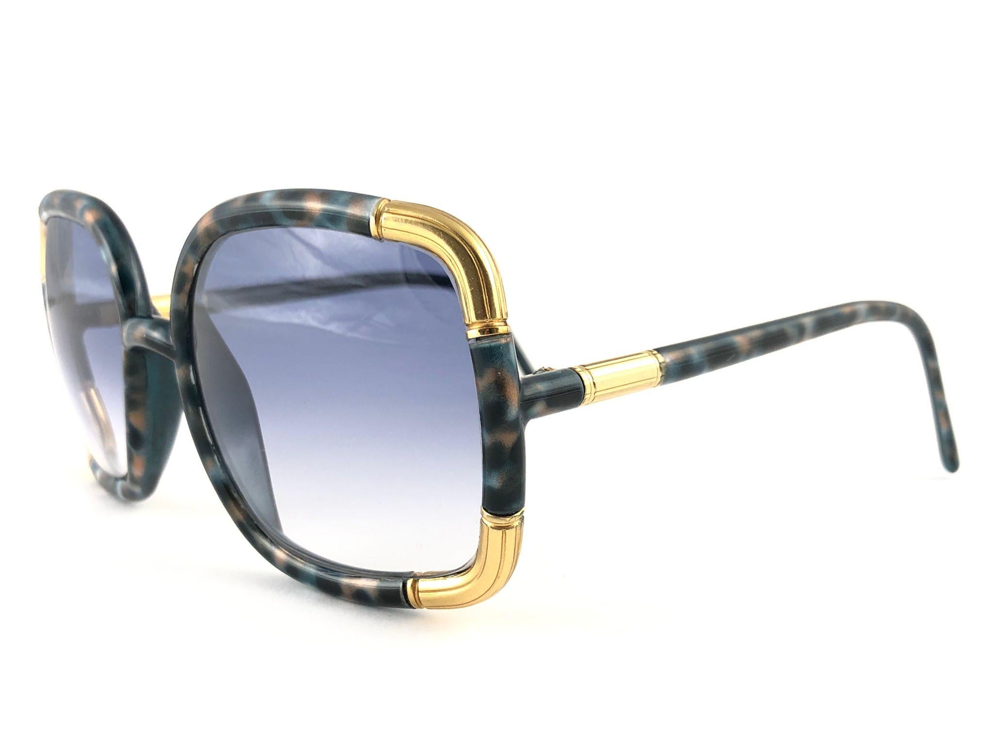 New Vintage Ted Lapidus Marbled Green-Blue and Gold details frame with gradient blue lenses. 

Please consider that this item its nearly 50 years old and could show minor sign of wear or discolouration due to storage. 

Made in Paris. Produced and