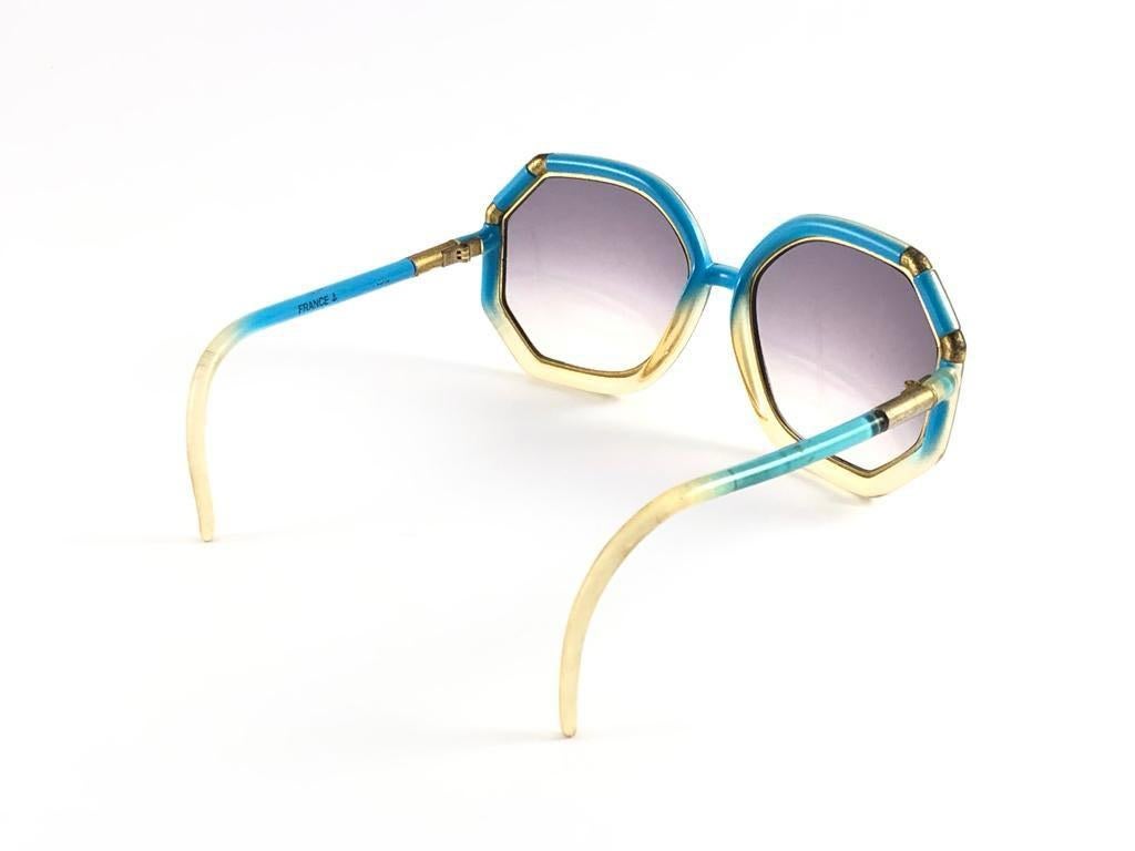 Mint Vintage Ted Lapidus turquoise with gold accents light gradient lenses.  
Made in Paris.  
Produced and design in 1970's.  
This item have sign of wear on the frame in a form or small tarnish on the gold. Please study the pictures prior