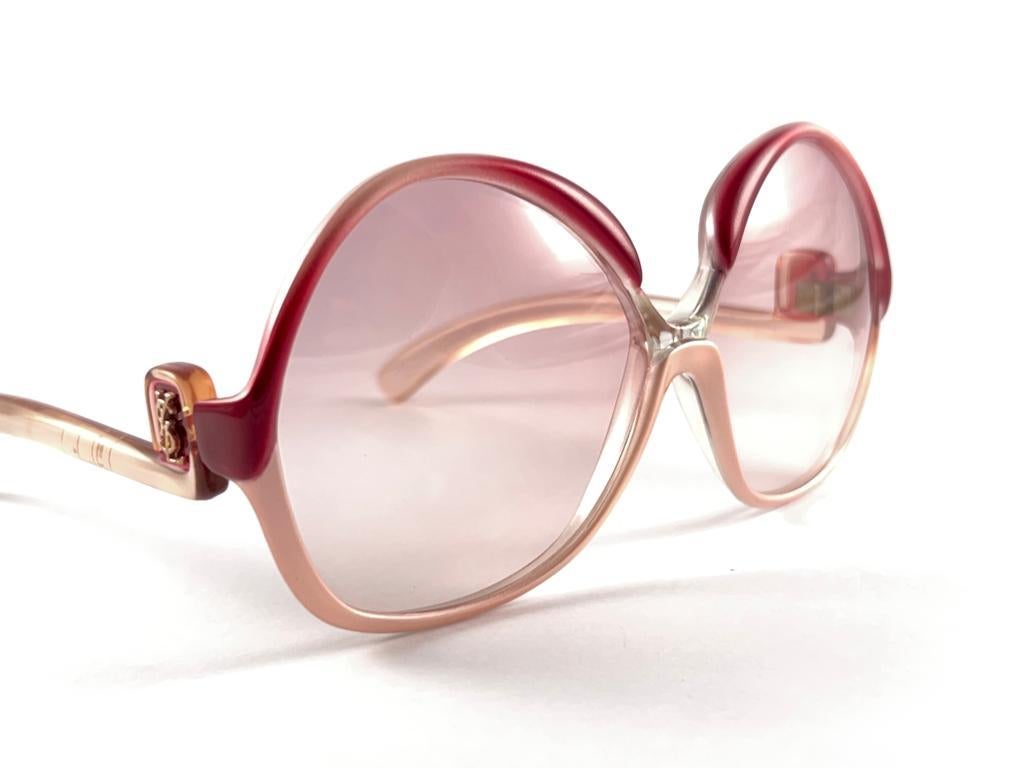 
Magnifique et élégante paire de lunettes de soleil surdimensionnées Yves Saint Laurent 1970's, monture robuste rose et bourgogne. Paire de lentilles rose clair impeccables.
Jamais porté ou exposé. 
Cette paire peut présenter des signes mineurs