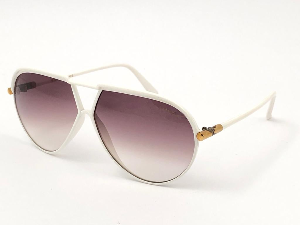 
Beautiful and stylish YSL sunglasses. White aviator frame holding a pair of double gradient lenses with beautiful old Cassandre logo.
This pair show minor sign of wear due to storage on the gold details, Please study the pictures. 
A great