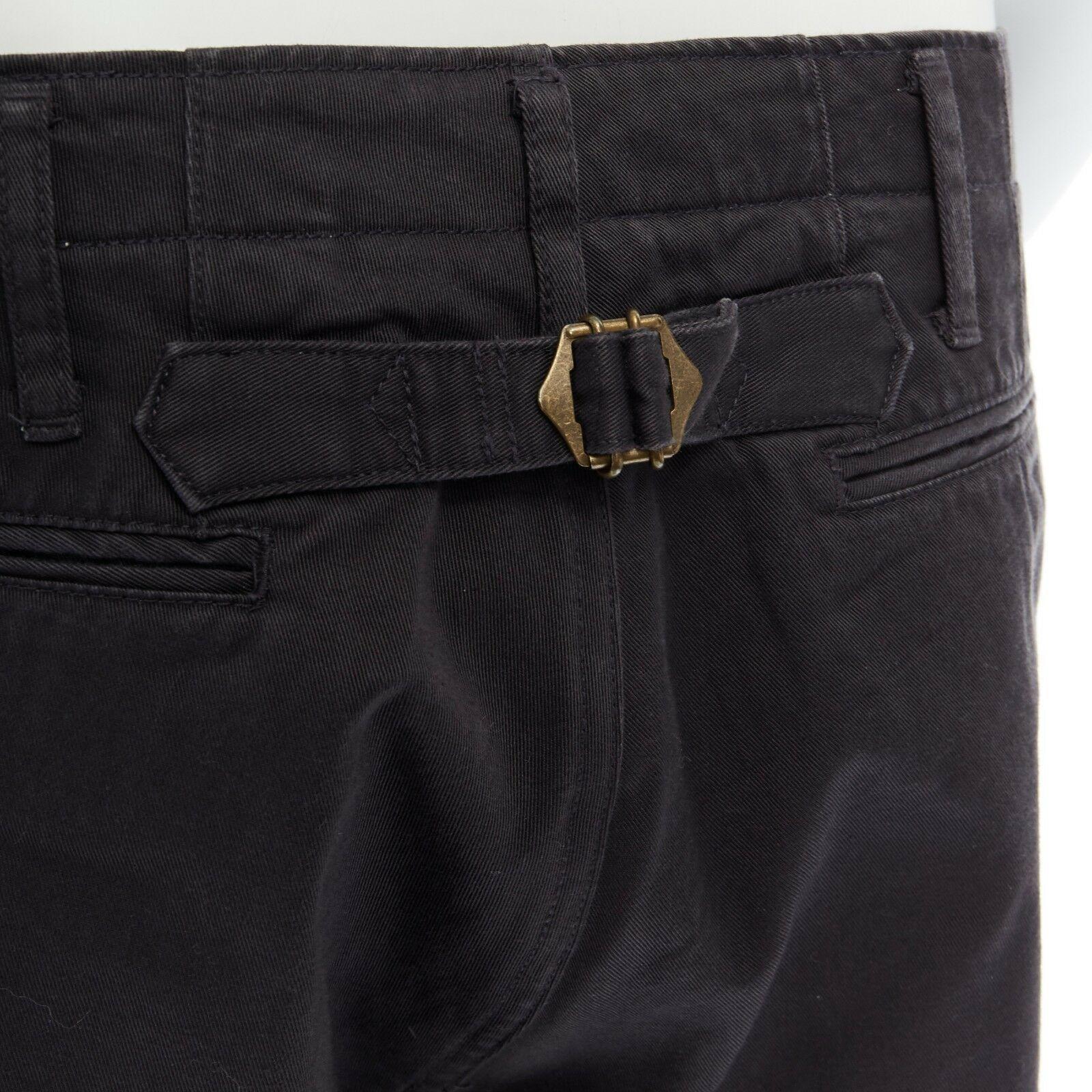 new VISVIM JAPAN 100% grey pull tab straight leg cropped pants JP2
VISVIM JAPAN
100% cotton. 
Belt loop detail. 
Button fly closure. 5-pocket design. 
Pull tab gold buckle detail at back. Mid rise. 
Straight leg. Cropped length. 
Made in