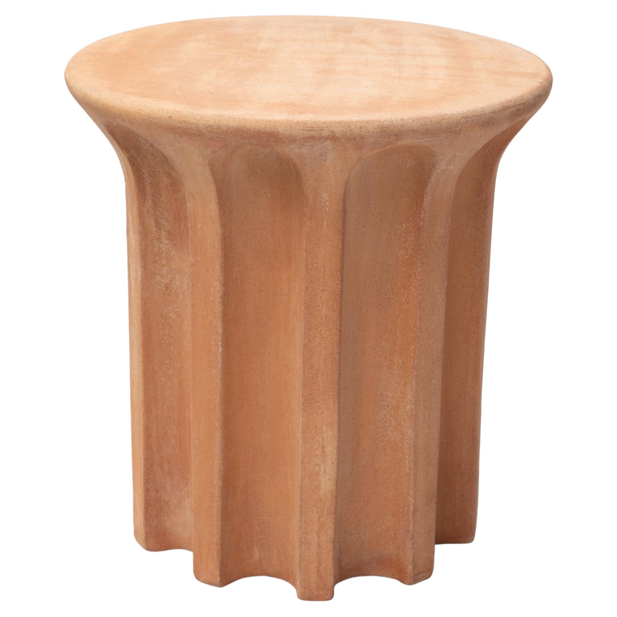Set comprises of 3 Echo High & 1 Echo Low

A robust terracotta side table featuring a revolving carousel of voids that call to mind the shapes used in architecture and design for centuries. A contemporary exploration of classical form that