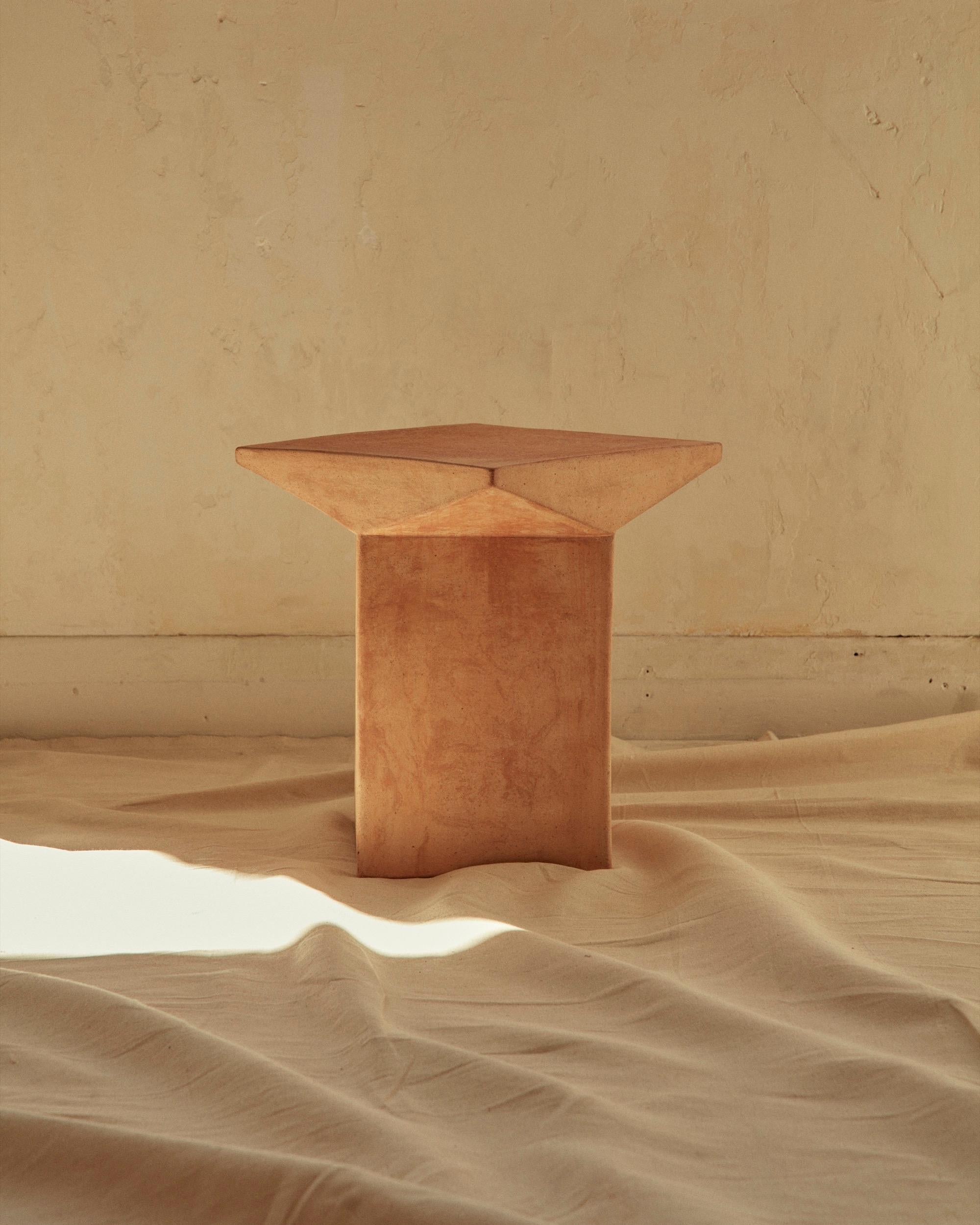 New volumes terracotta pitcher stool by Adam Goodrum.

Capturing the purity of geometry and mathematical balance, New Volumes Pitcher Stool designed by Adam Goodrum features an extruded square base with the top rotated 45 degrees, then married