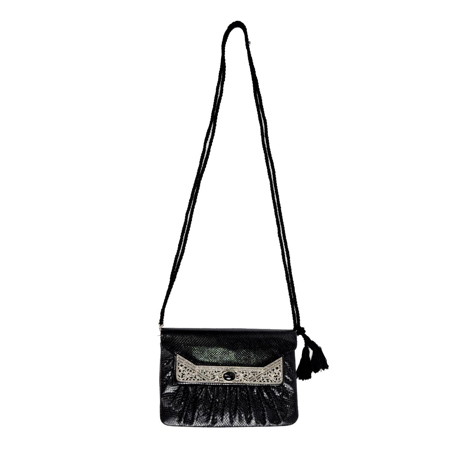 This is a lovely deadstock vintage Judith Leiber handbag with a beautiful marcasite front embellishment with a center black cabochon. The bag has an inside zipper, open side pocket, removable black rope shoulder strap with tassels, to convert it