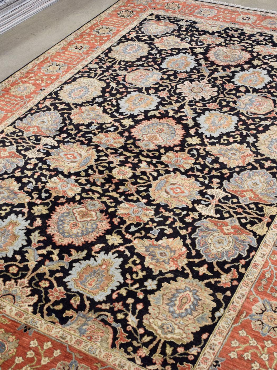 Warm, dramatic, and pleasantly inviting, this wool Agra carpet measures 6’ x 9’1” and is hand-knotted in red-orange, black, gray, pink, and gold wool. Crafted in India circa 2016 and created using a Persian-inspired weave, this carpet is in new