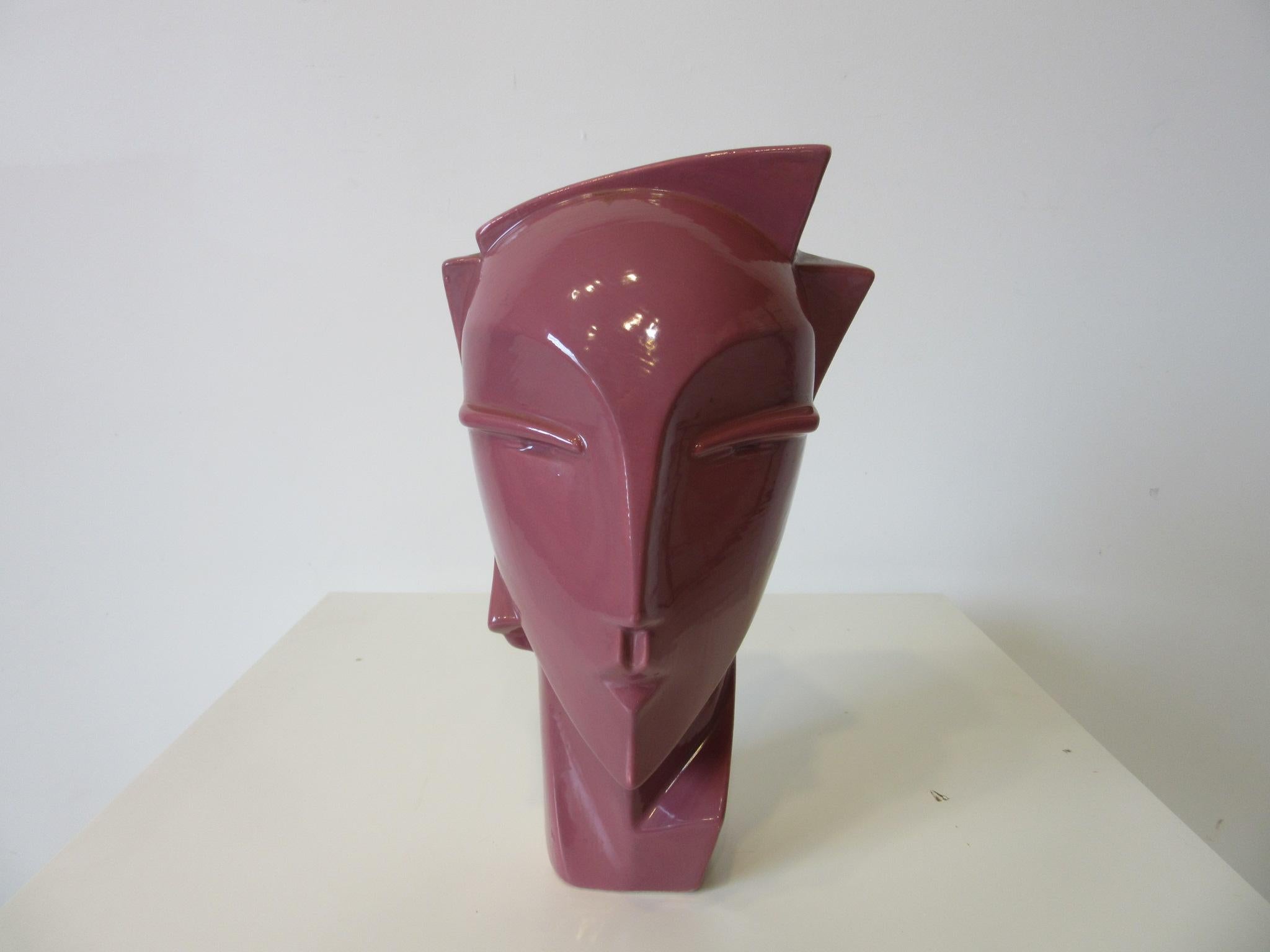 A glazed pottery head sculpture in the style of new wave / Art Deco and Grace Jones in the color of the 1980s manufactured by the Haeger Pottery company.