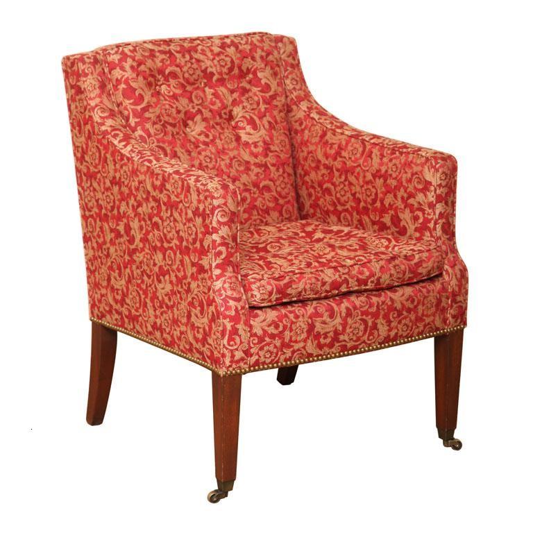 New Wood & Hogan Sheraton style smart, tailored armchair with deep-seated comfort on tapered Mahogany legs.  Front legs terminating with solid brass casters. Inside back and loose down seat cushion buttoned.  Base of chair with antiqued brass nail