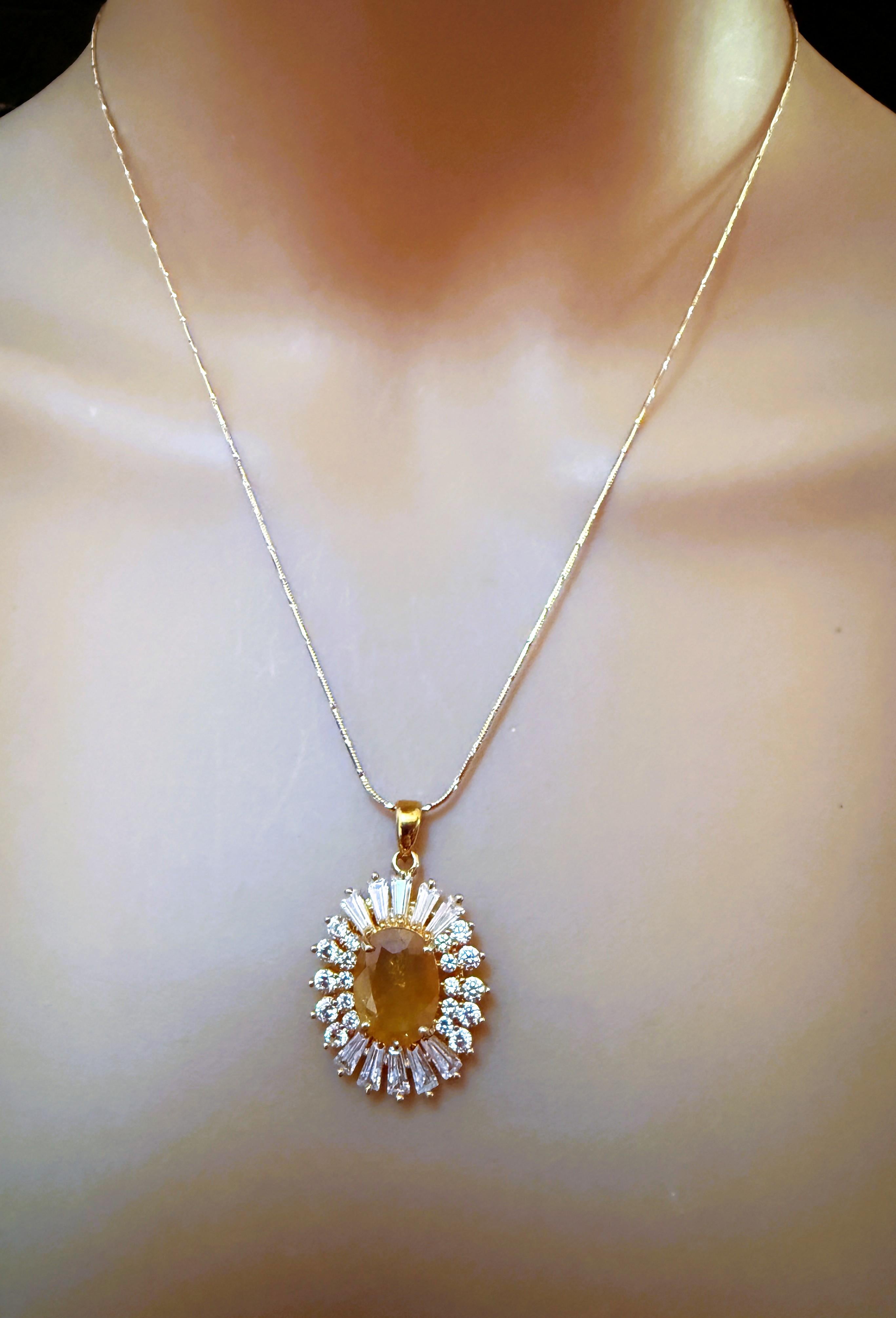 This is just a gorgeous necklace!  The stone is an oval yellow sapphire and is 5.05 carats.  It is 13 x 9 mm and is in a gorgeous 24k Yellow Gold Plated 925 Sterling Silver Setting.  There are 10 diamond cut sapphires on either side of the stone and