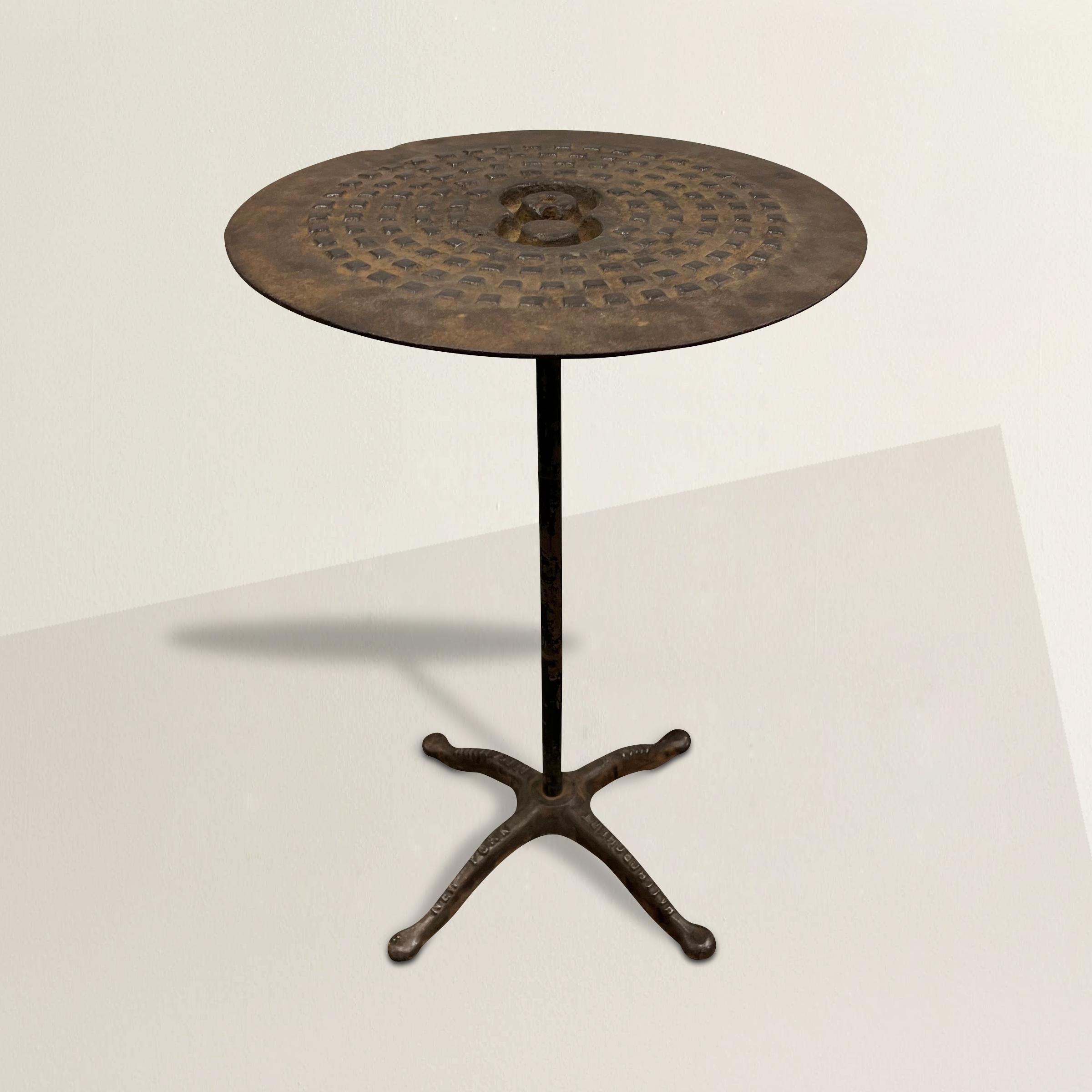 A whimsical and steadfast side table with a top made from a New York City manhole cover and with the number 8 cast into the top. The base is from a dressmaker's dress form. The perfect drinks table next to your favorite armchair, side table next to