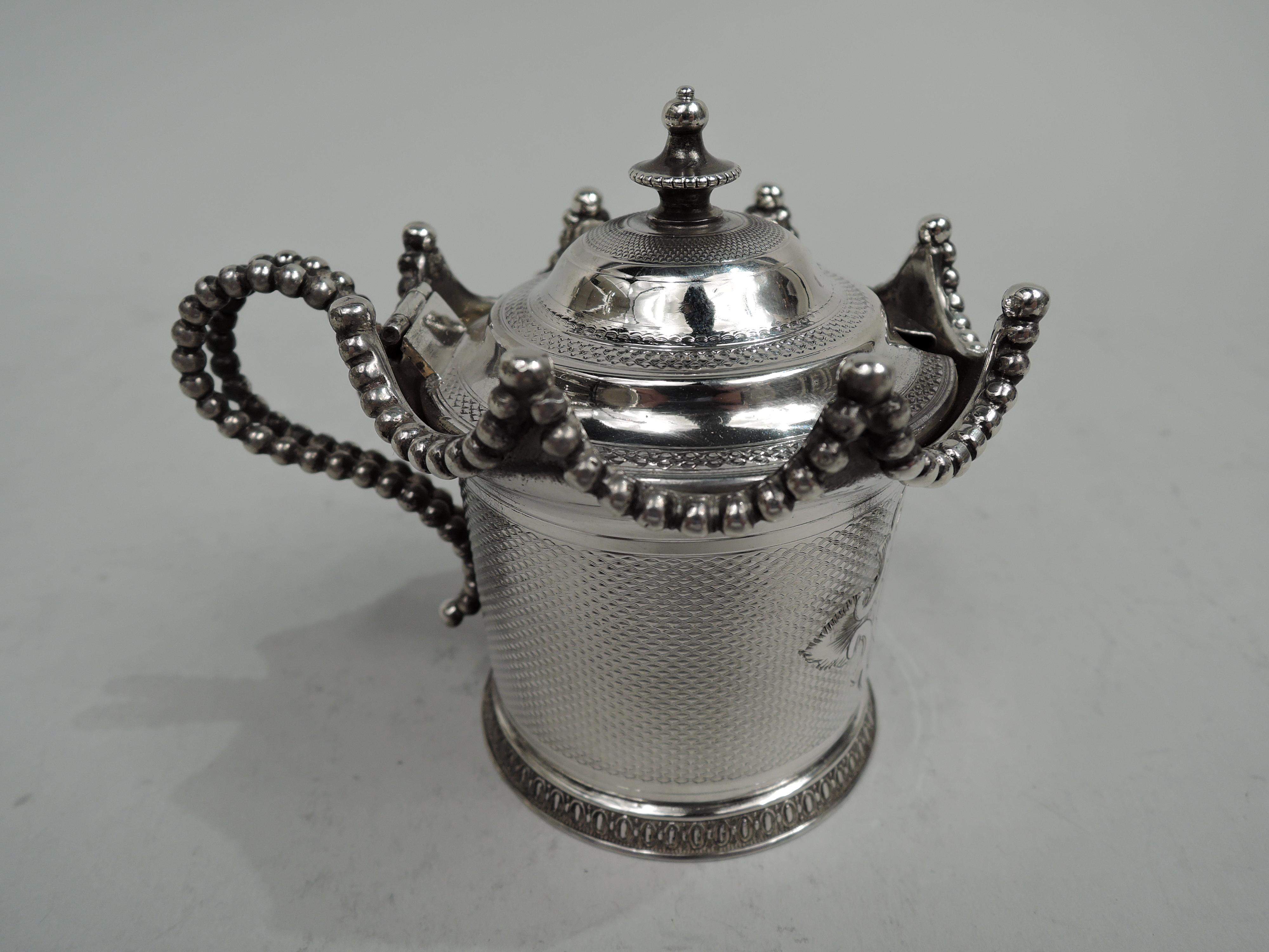 Classical coin silver mustard pot. Made by Wood & Hughes in New York, ca 1850. Drum-form bowl and spread foot with egg-and-dart border on lined ground. Beaded pavilion-style wavy rim and split and beaded high-looping handle. Cover hinged and domed