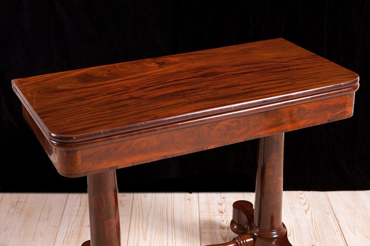 A very handsome card or games table with hinged top that opens and pivots to a square over a trestle base with round-tapering columns and turned stretcher. Attributable to cabinet maker, Meeks & Sons. New York City, circa 1830.
Measures: 35