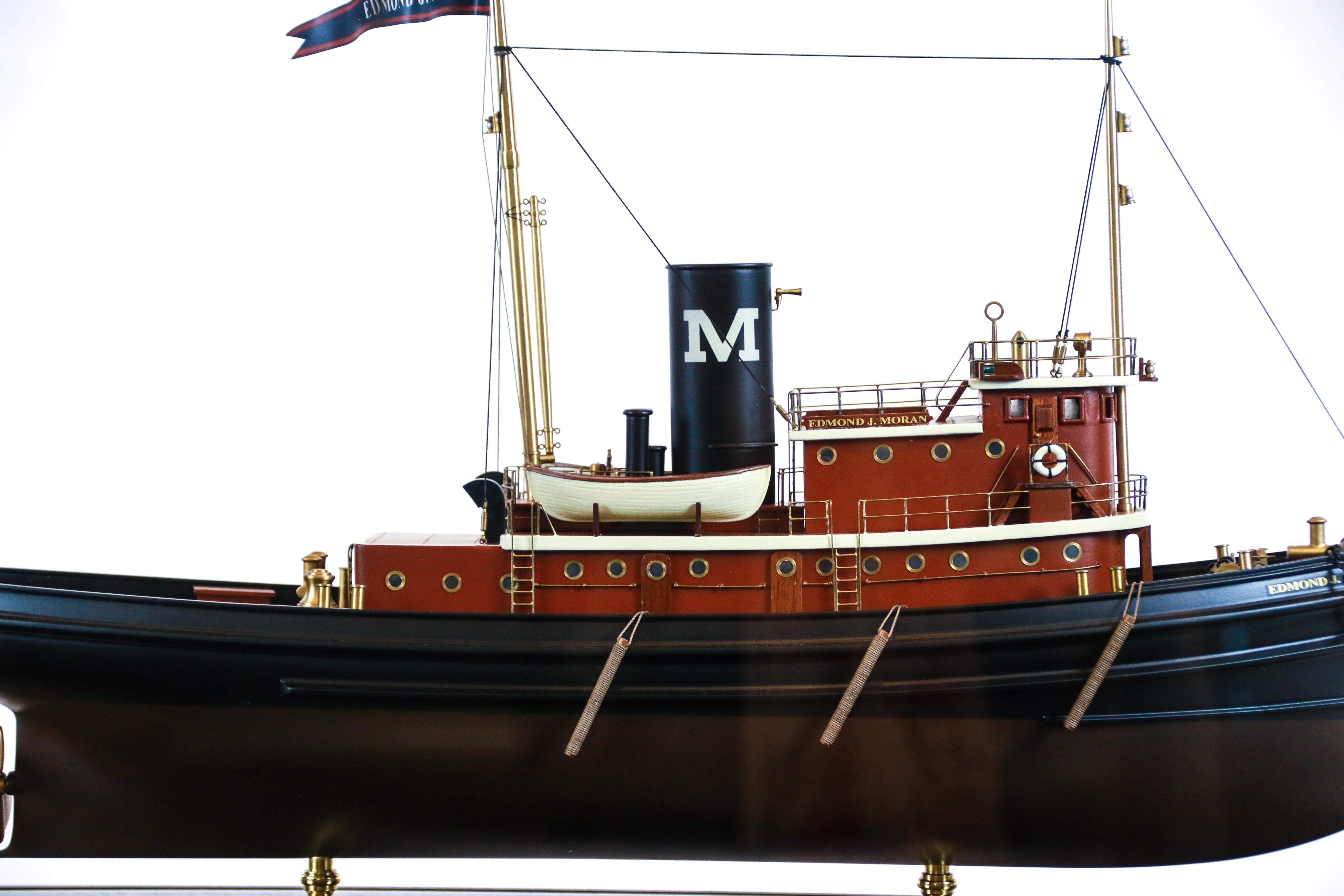 Moran Tug in display case of glass and brass trim. Model details include stack, helm, wheelhouse, binnacle, capstan, spotlight, lifering, portholes, ladders etc... 
Moran Towing traces its origins to 1855, when Michael Moran, a 22-year-old