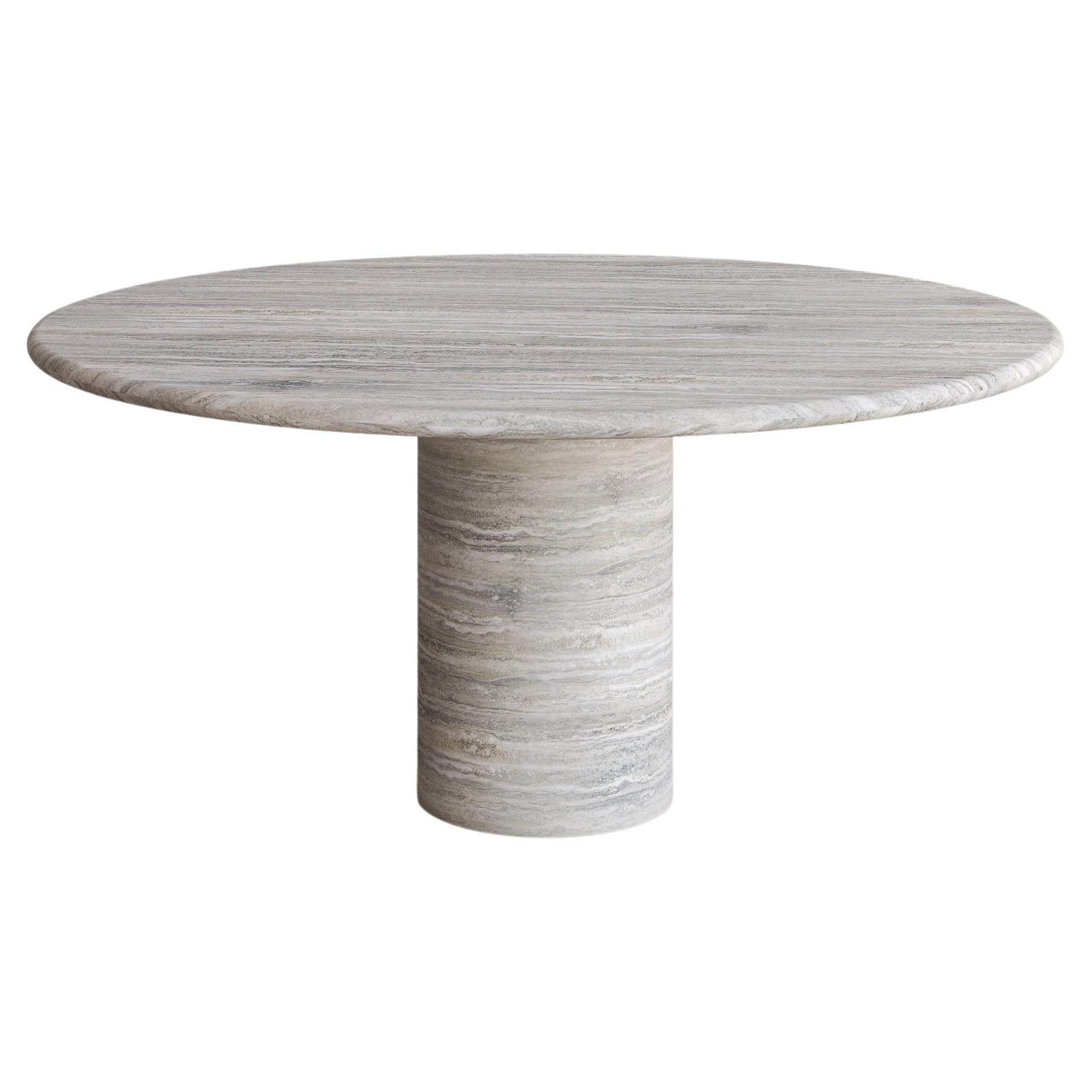 The Voyage Dining Table I in Silver Travertine with a honed finish by The Essentialist celebrates the simple pleasures that define life and replenish the soul through harnessing essential form. Envisioned as an ode to historical elegance, captured