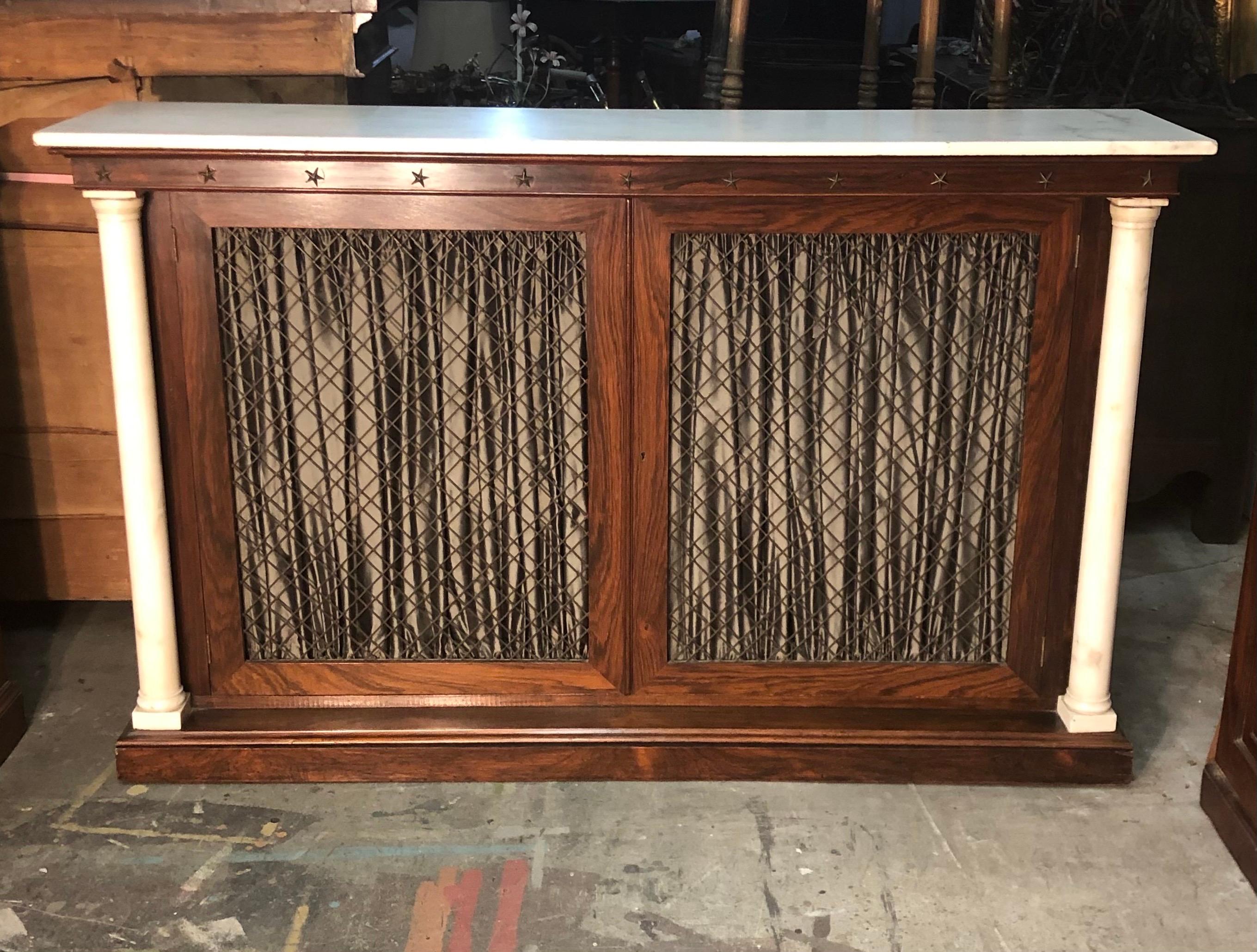 This New York Marble Column Rosewood Bookcase / Credenza With Marble Top is made in the Neoclassical Style in the early 19th Century. The Credenza is Rosewood veneer with elegant Carrara marble columns and top. The Bookcase has bronze five tip stars