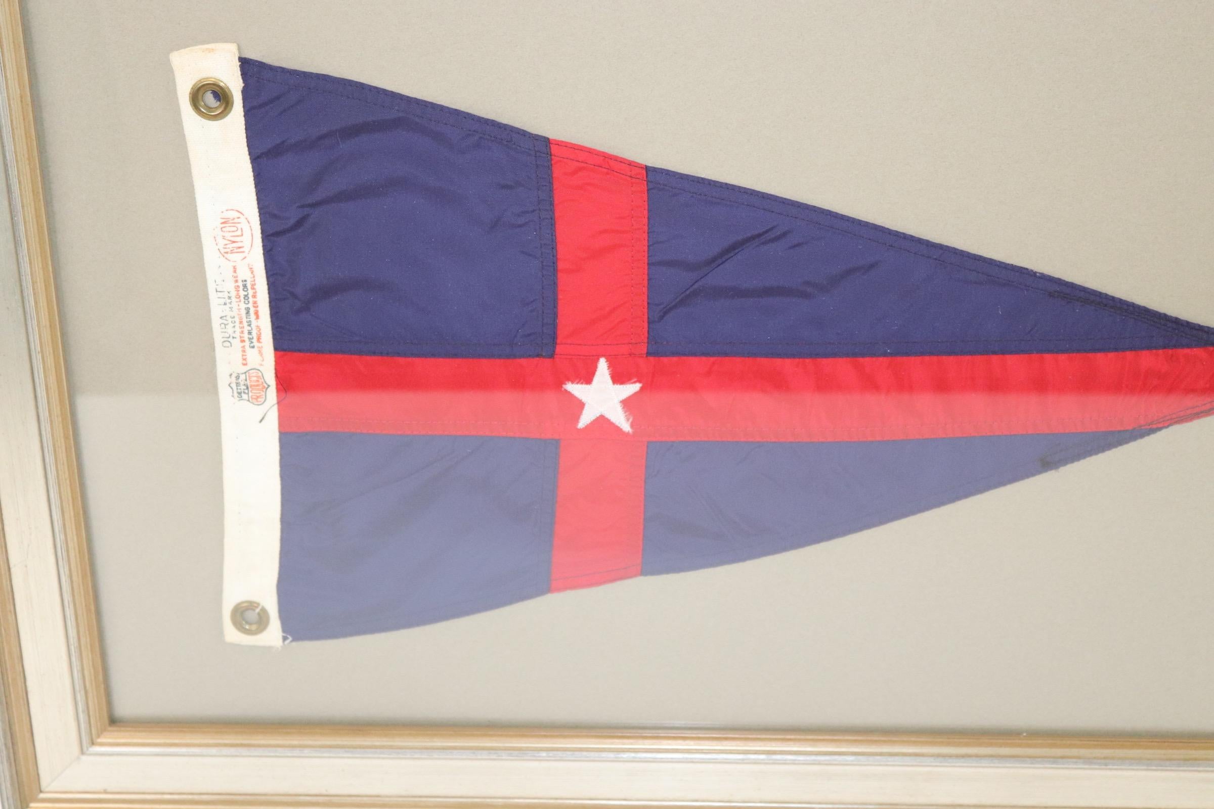 Framed New York Yacht club burgee. With NYYC logo of white star over blue field with red stripes. Weight is 8 pounds.
