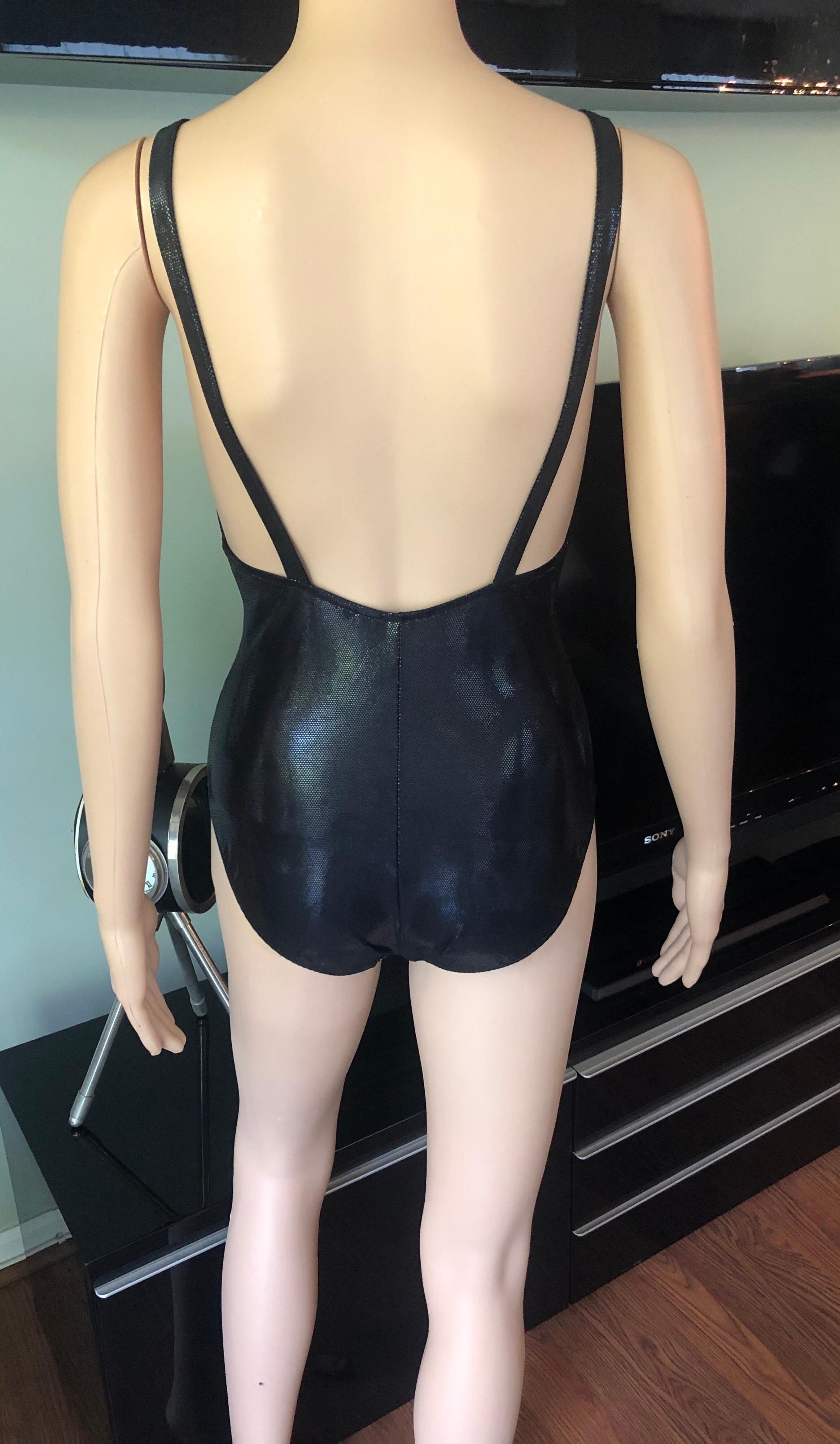 New Yves Saint Laurent YSL Plunging Open Back Metallic Wet Look Black One-Piece Swimsuit 

Yves Saint Laurent one-piece metallic black swimsuit featuring plunging neckline and open back.
