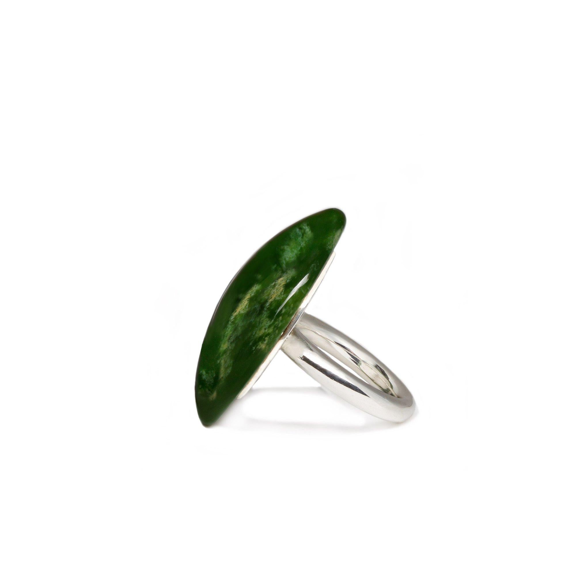 
This immaculate polished greenstone ring has been carved from New Zealand by a local artist. This Flower Jade Dome Ring stands out in the Sterling Silver. And Pounamu means green gem in New Zealand.  