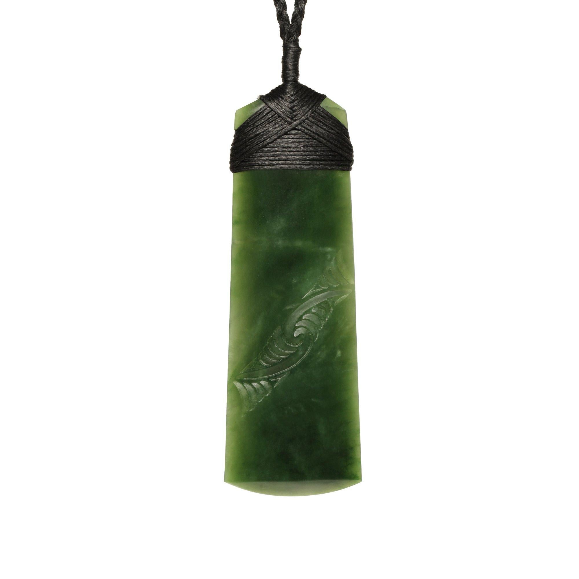 
New Zealand Jade Necklace  which has been hand carved and you can see the design in it the stone  In New Zealand these have meaning traditionally 

. Pournamu means green Gem and  Toki  means a  symbol of strength and carries with it deep symbolism