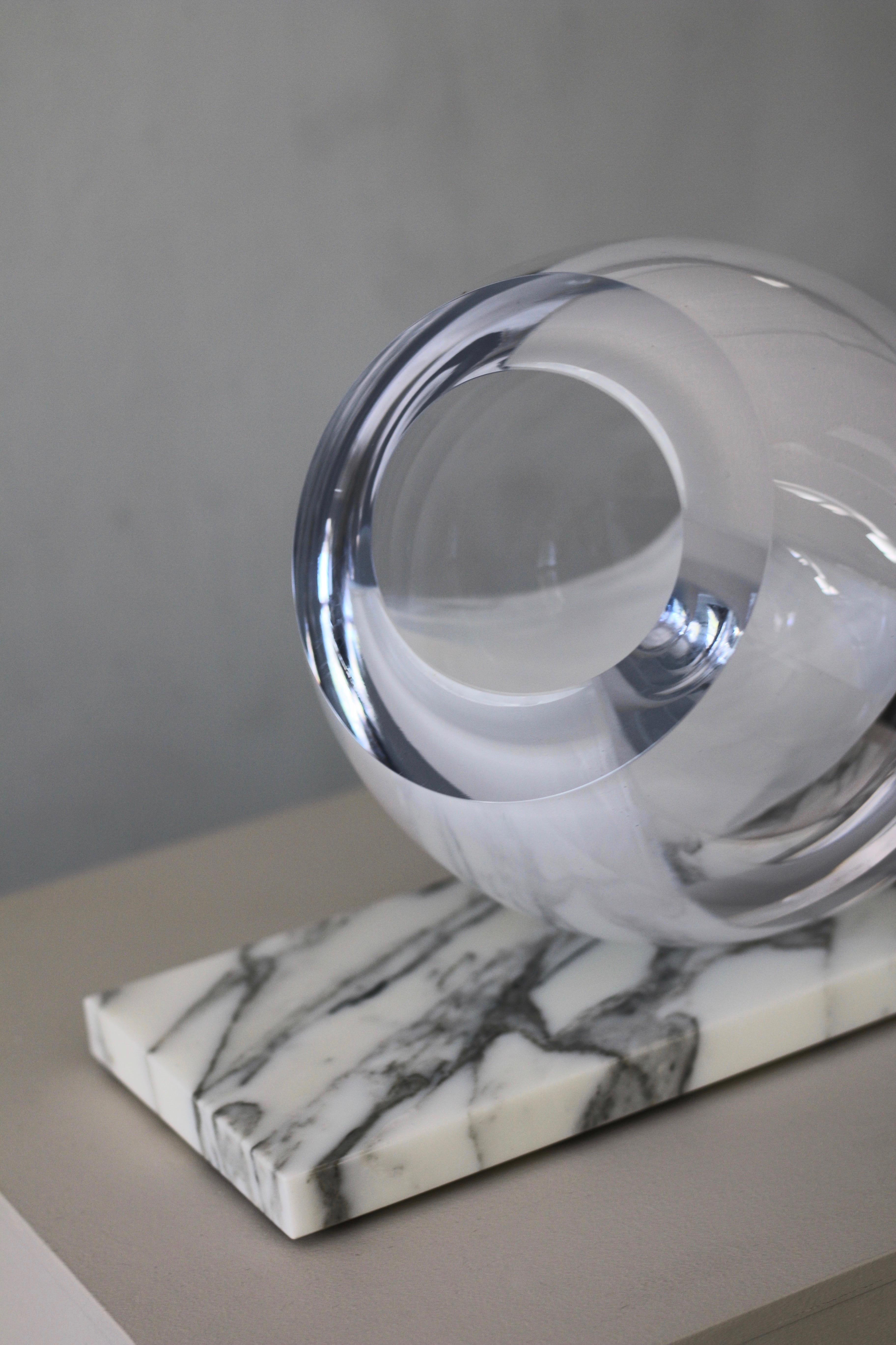 'Newborn' sculptural vase from collection 'Mother Creation’. 
Contemporary minimalist design in free form mouth blown glass with white tinting on polished Calacatta marble in cream and grey. 

Glass detail sits in a marble cut and can be