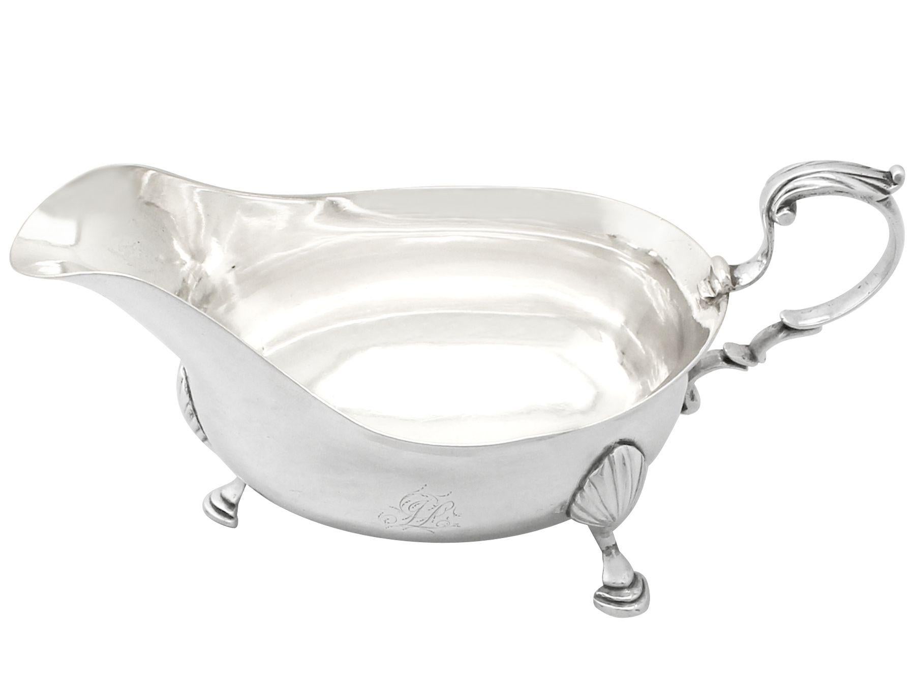 A fine and impressive antique Georgian Newcastle sterling silver sauce boat made by John Langlands I & John Robertson I, an addition to our silver dining collection.

This exceptional antique Georgian sterling silver sauce boat has a plain oval