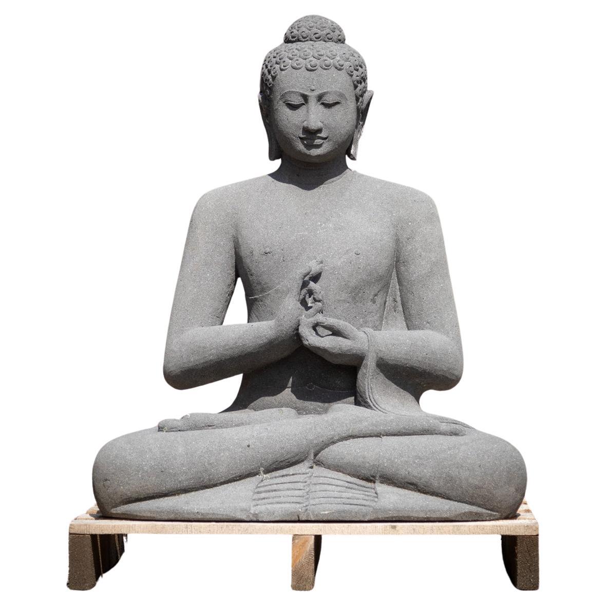Newly made lavastone Buddha statue in Dharmachakra mudra 