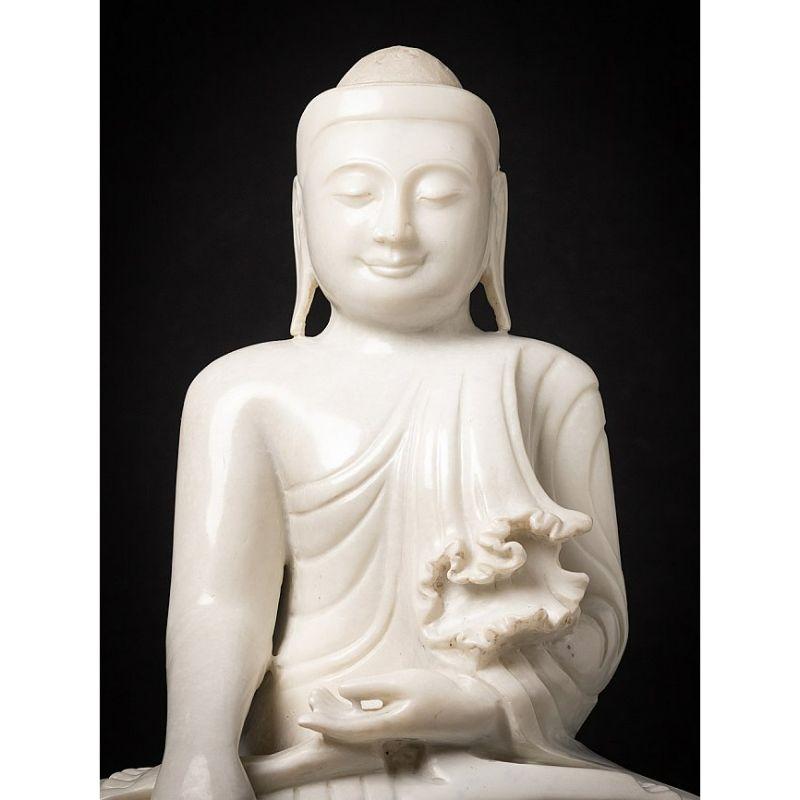 Material: marble
Measures: 61,5 cm high 
47,5 cm wide and 25 cm deep
Weight: 57.8 kgs
Mandalay style
Bhumisparsha mudra
Originating from Burma
Hand carved from a single block of white marble
Can be shipped worldwide.

