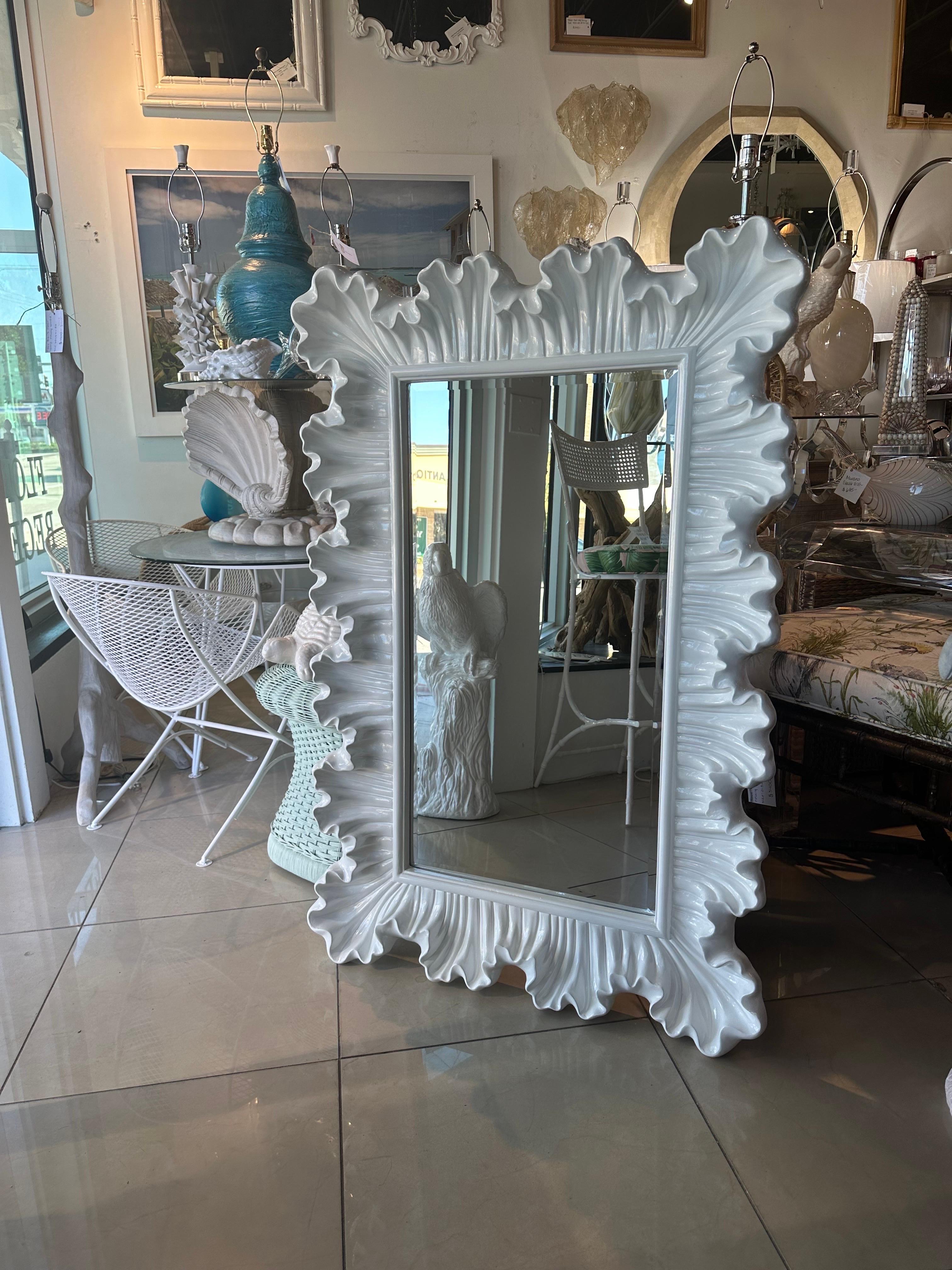 Lovely vintage ruffle scalloped composite wall mirror. This has been newly lacquered in a white gloss. New mounting hardware installed. Dimensions: 48.5 H x 32.5 W x 3 D. 